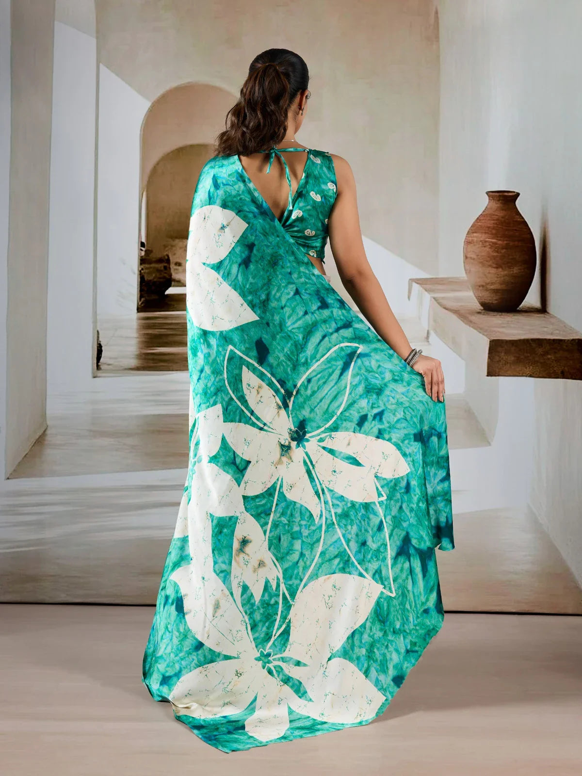 Tarani green saree back view showing full pallu spread and tie-up blouse back