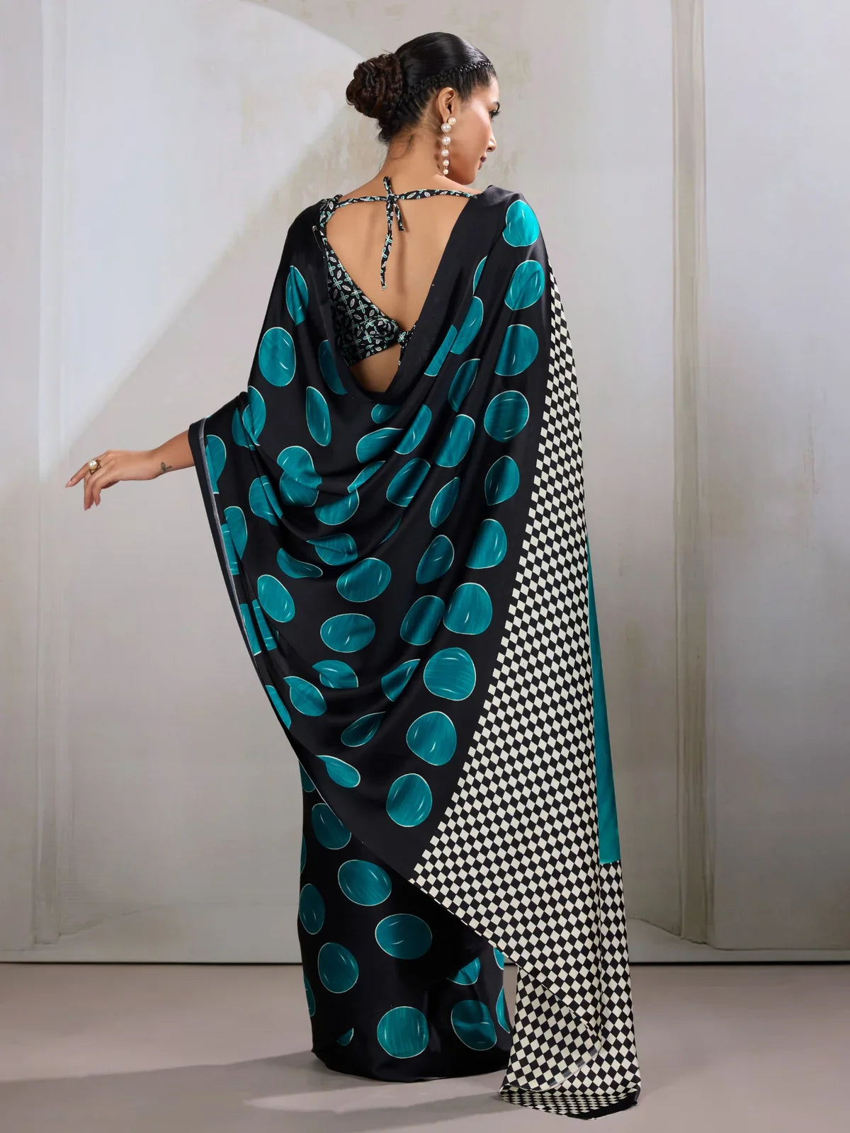 Tarani modal satin saree back view highlighting teal motifs and back blouse design