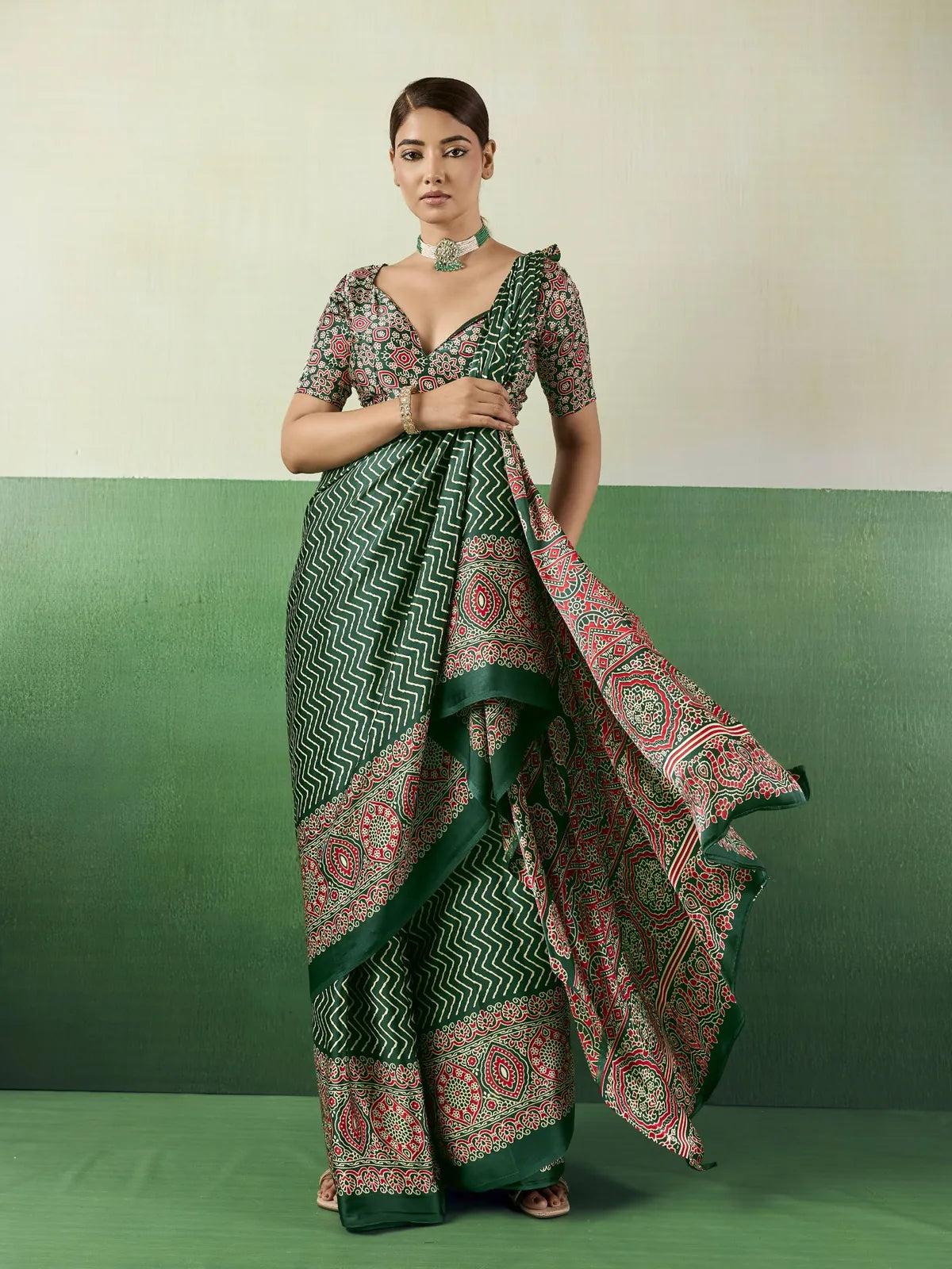 Tarani green Ajrakh print modal satin saree front view with flowing pallu and designer blouse