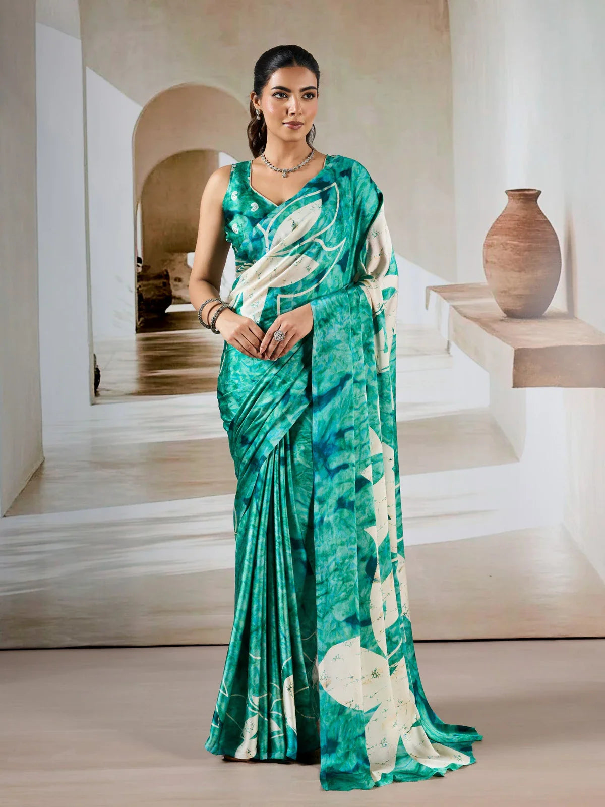 Tarani green modal satin saree full view with bold leaf design and contrast blouse