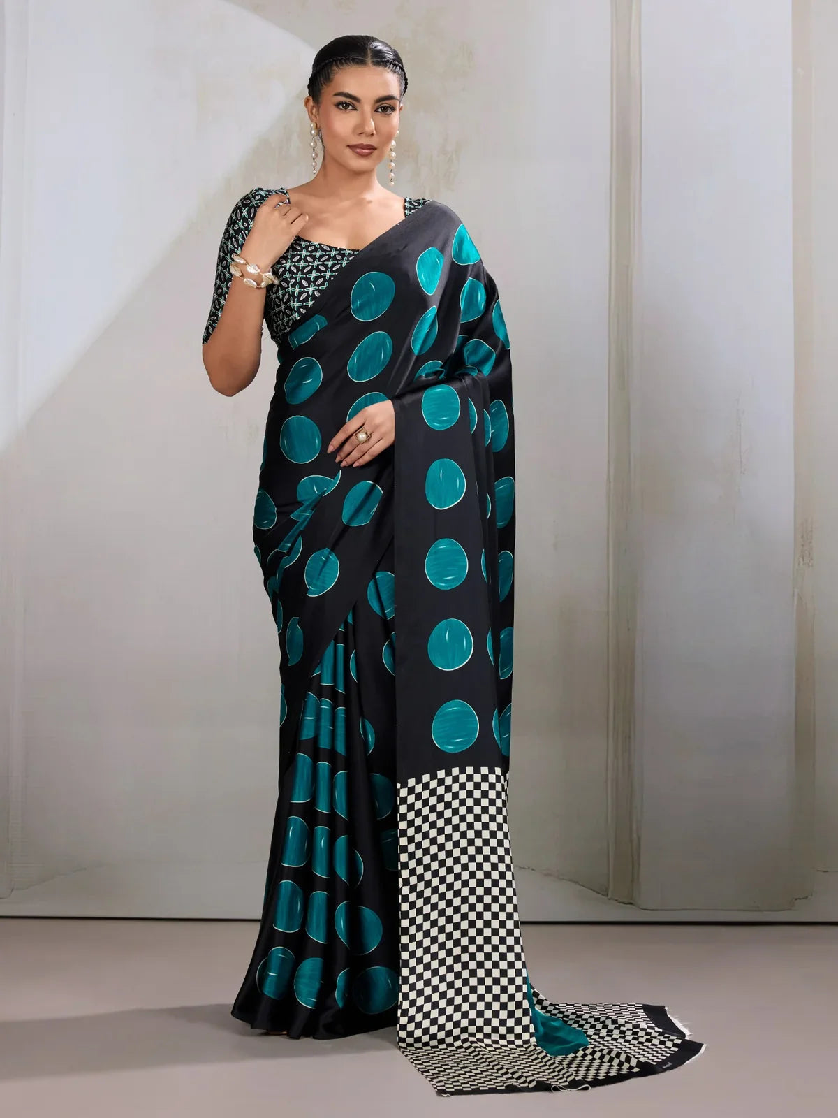 Tarani modal satin green saree full view with bold teal dots and festive black base