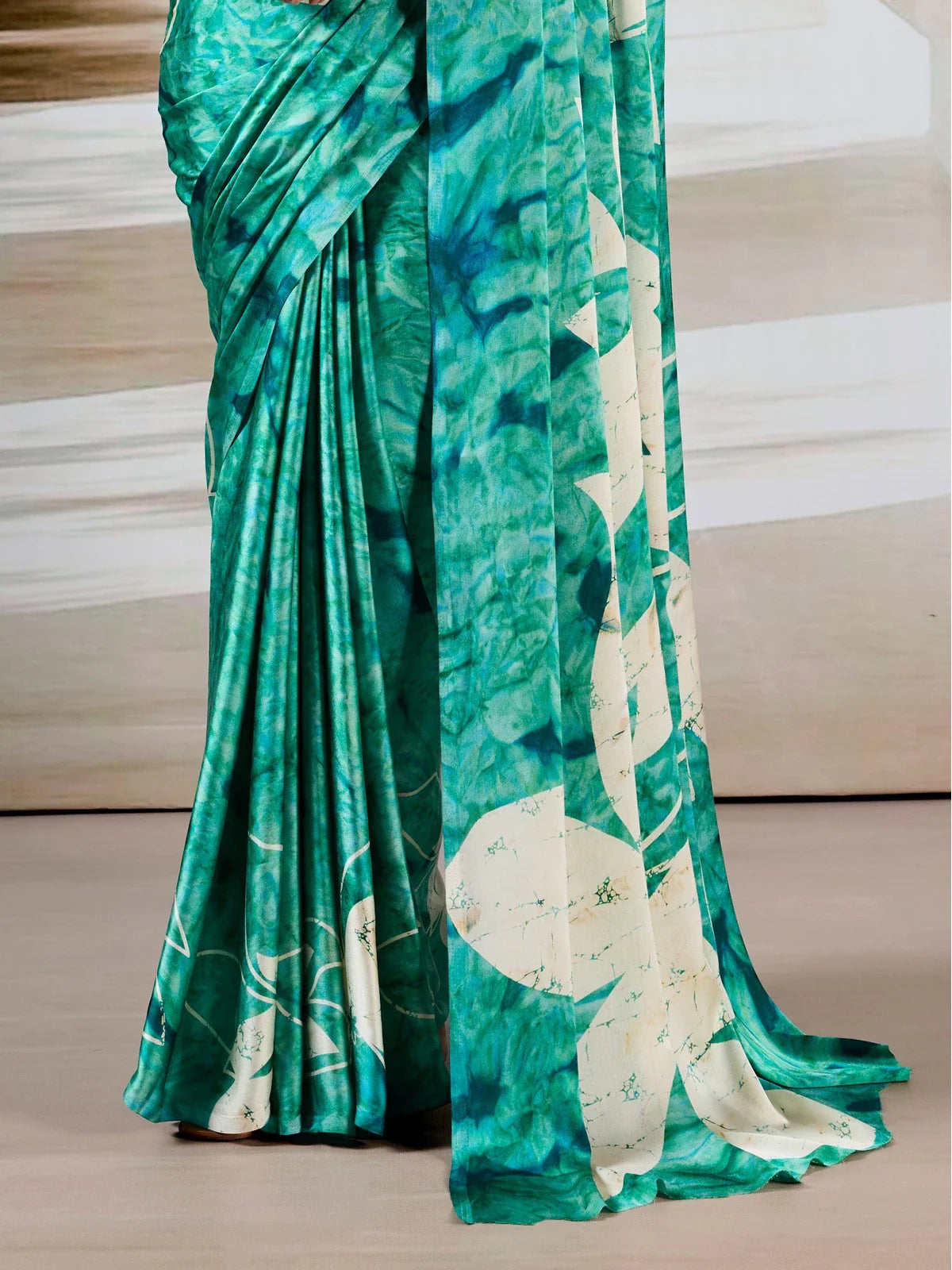 Tarani green saree pallu featuring large floral batik-style white motifs