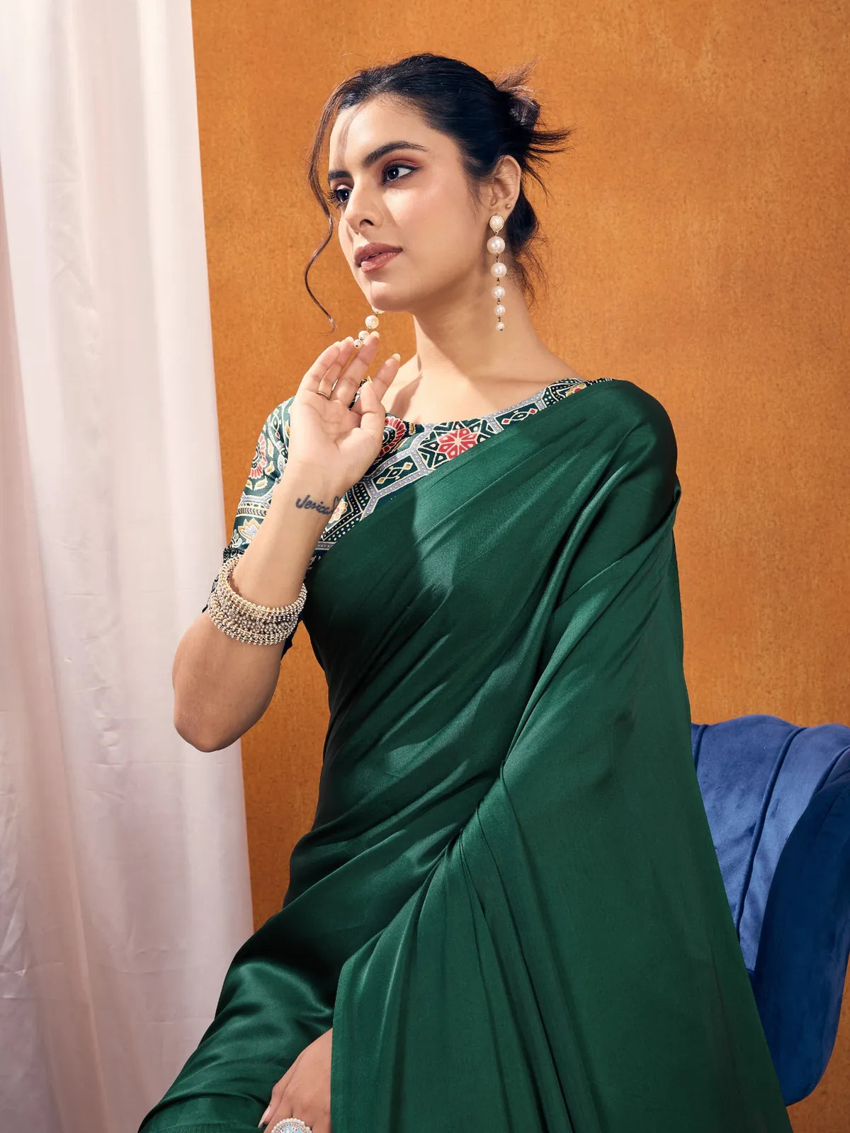Tarani modal satin saree in green showing upper body view and printed blouse
