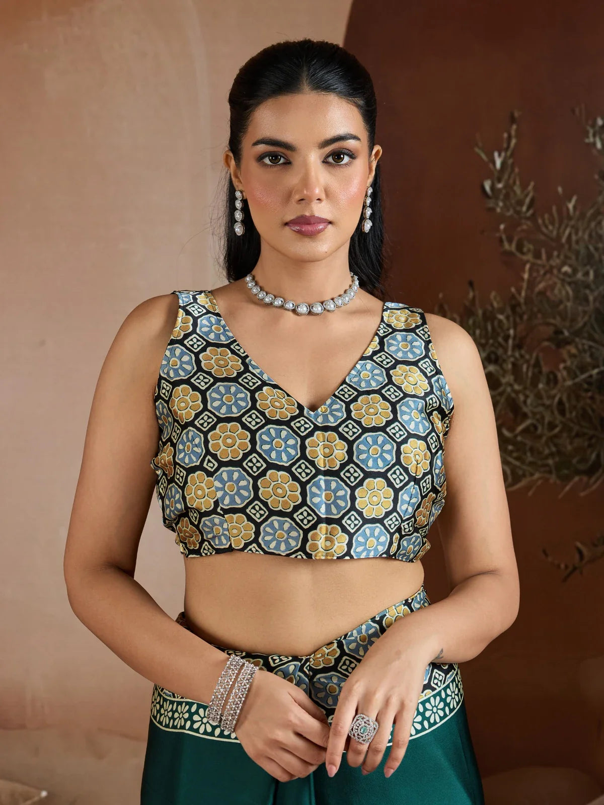 Tarani close-up front upper body view of Ajrakh printed blouse paired with green saree