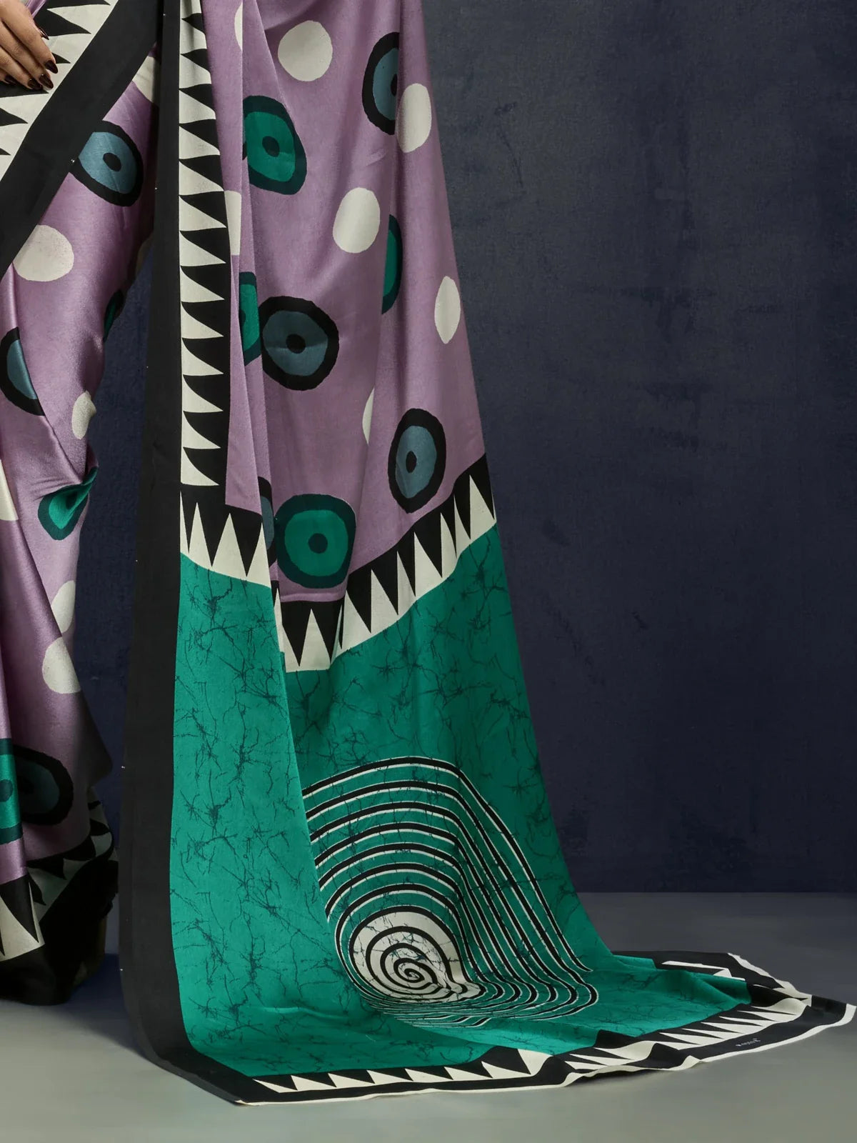 Tarani modal satin saree pallu closeup with turquoise base and spiral motif