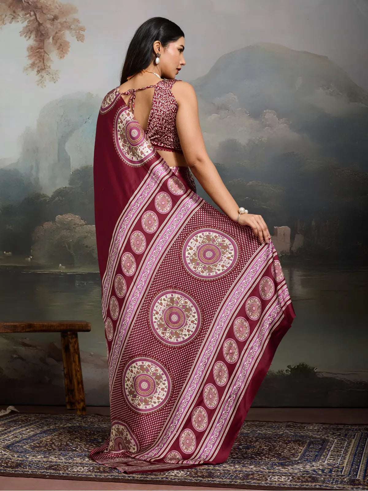 Tarani back view of maroon saree with rich circular prints and open back blouse tie-up style