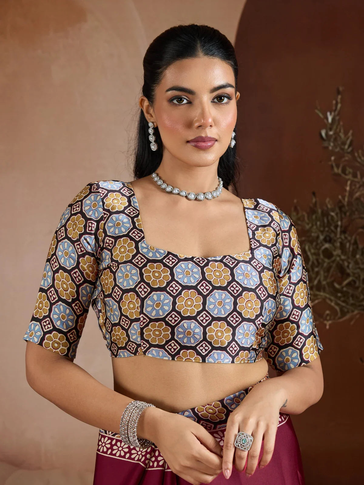 Tarani modal satin saree close-up showing printed blouse design and jewelry styling