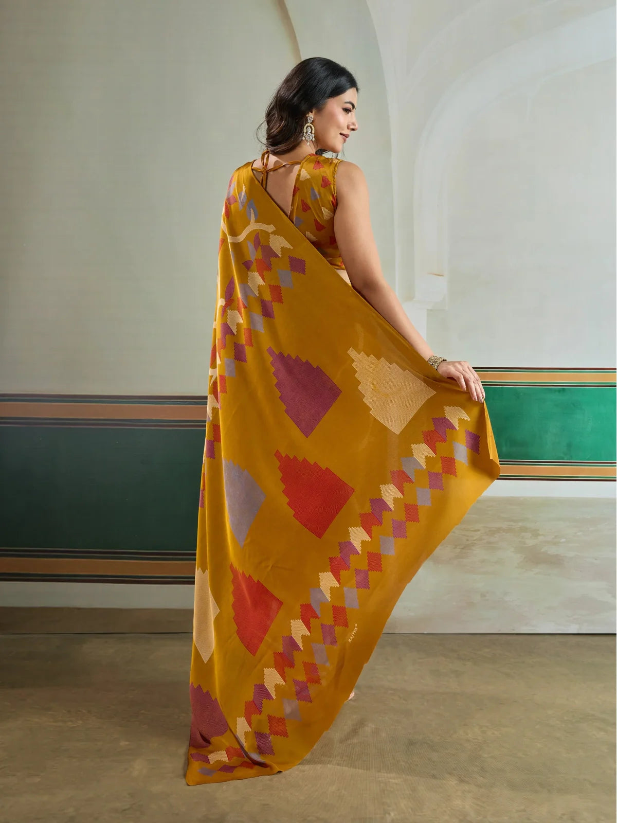 Tarani mustard saree full back view showing multicolor pallu design and elegant drape from Tarani