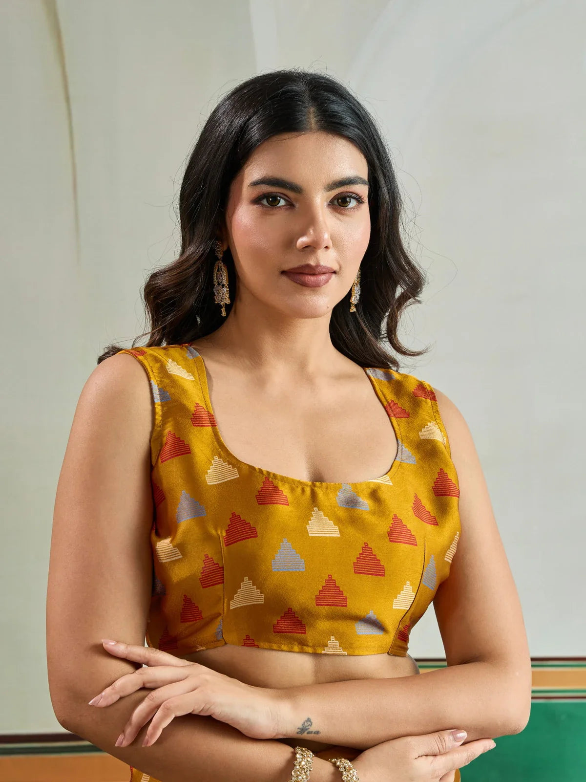 Tarani mustard modal satin blouse close-up with multicolor pyramid motifs in red, cream and blue for Ajrakh saree