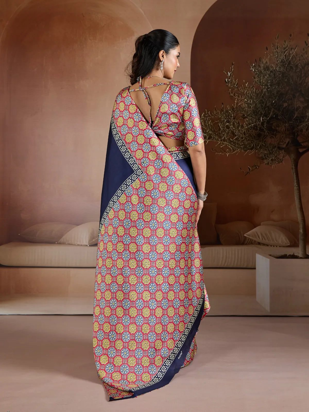 Tarani back view of blouse and saree with elegant tie-up design in printed pattern and navy blue drape