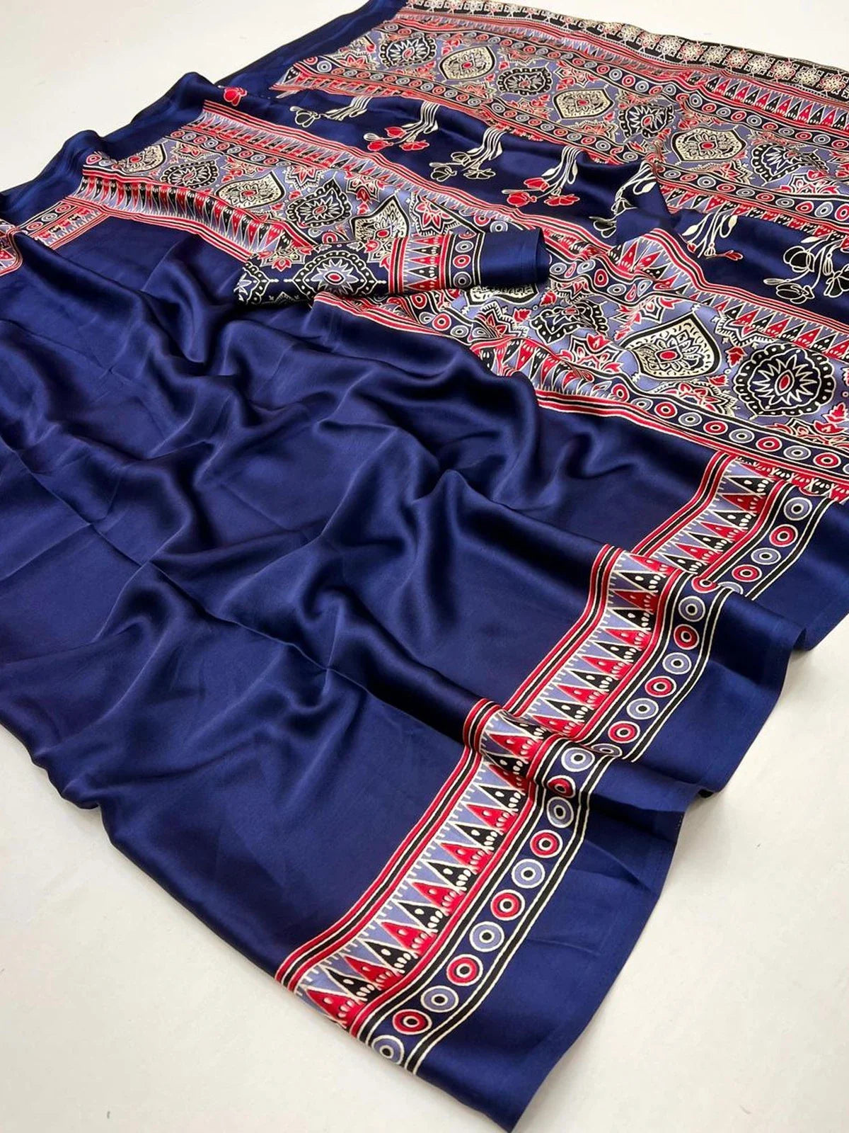 Tarani navy blue modal satin ajrakh saree laid flat showing fabric texture and intricate border work