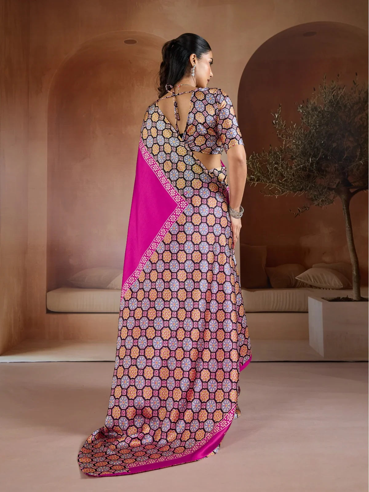 Tarani pink saree back view showing full drape and blouse tie-up pattern