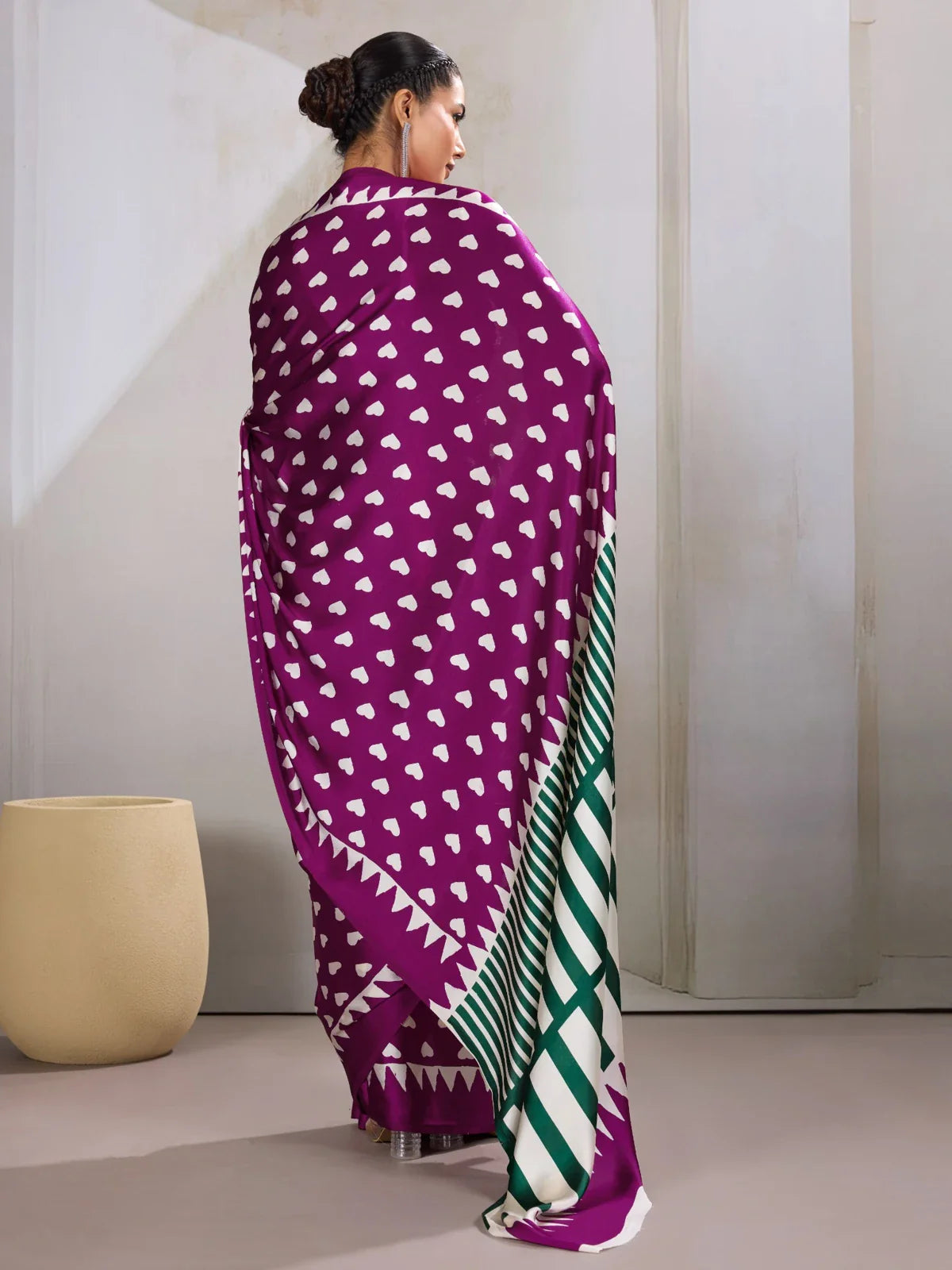 Tarani back view of purple modal satin saree highlighting flowy fabric with bold pallu accents