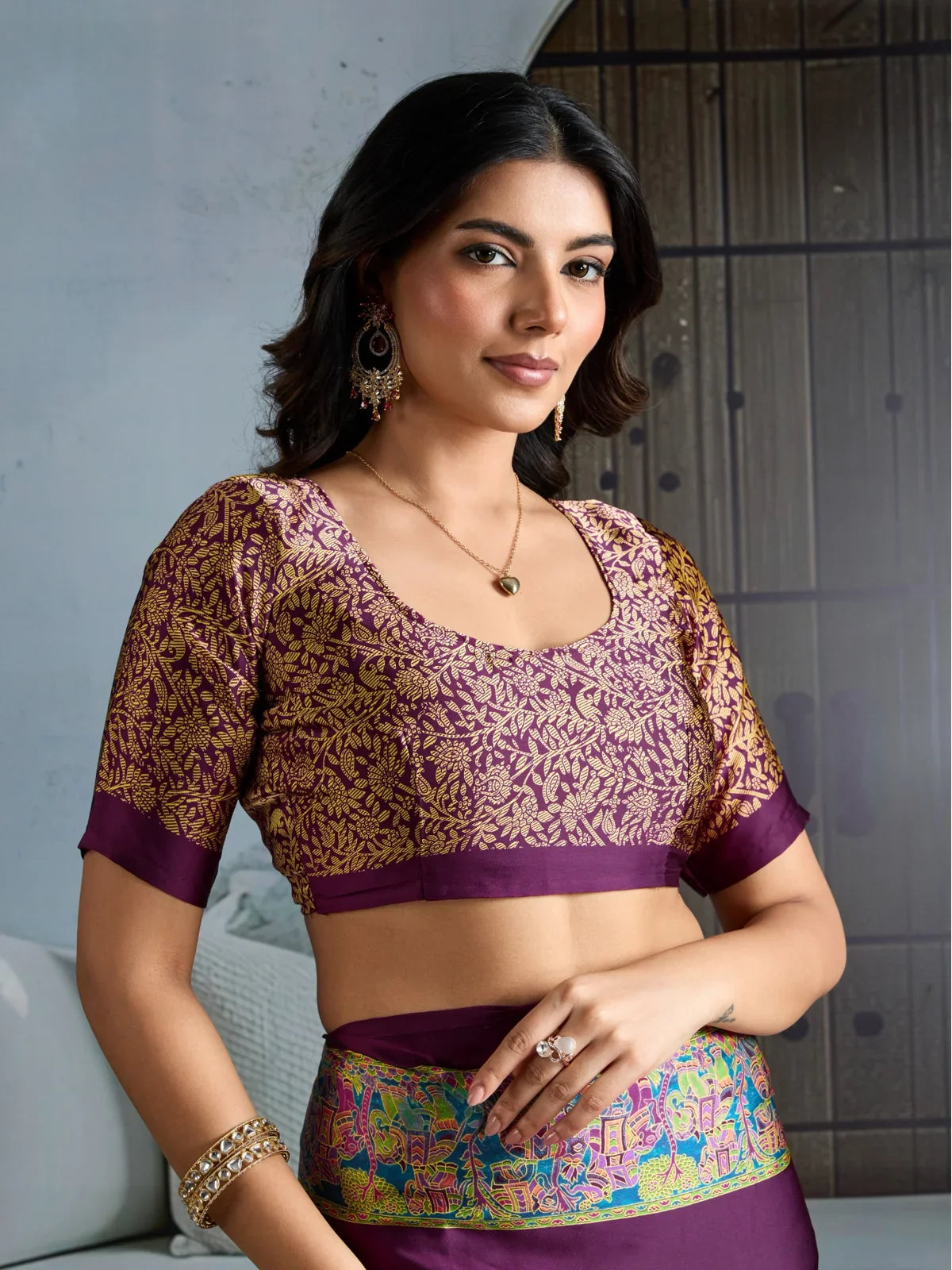 Tarani close-up view of blouse with intricate gold floral embroidery on purple base