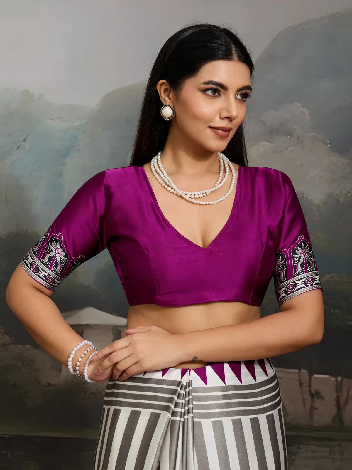Tarani close-up of purple modal satin blouse with printed sleeve paired with ajrakh print saree