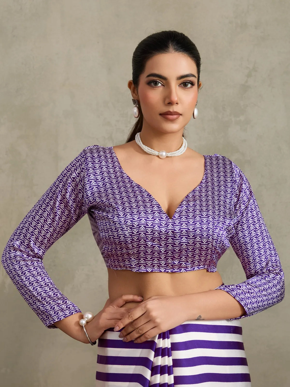 Tarani modal satin saree upper-body closeup showing detailed blouse design in purple geometric print