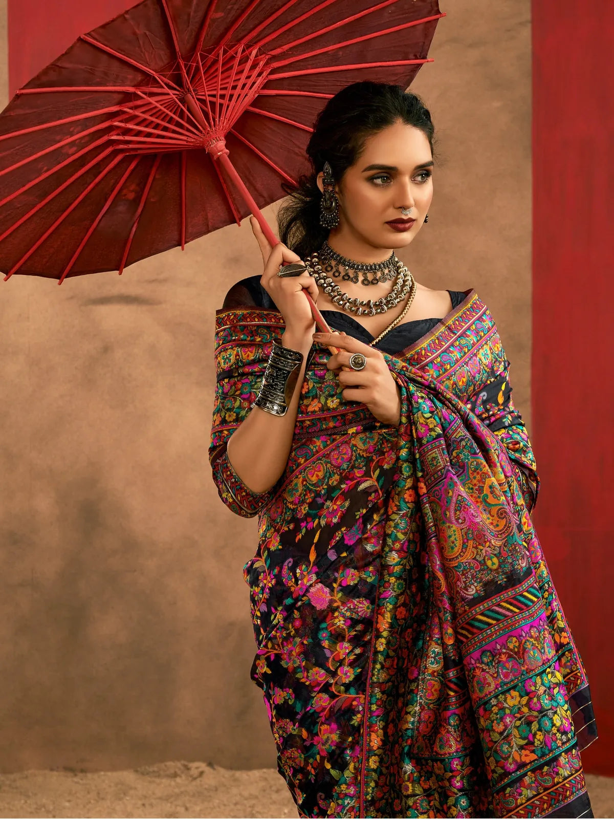 Tarani black pashmina style saree in model cotton fabric with rich floral weaving and bold ethnic charm