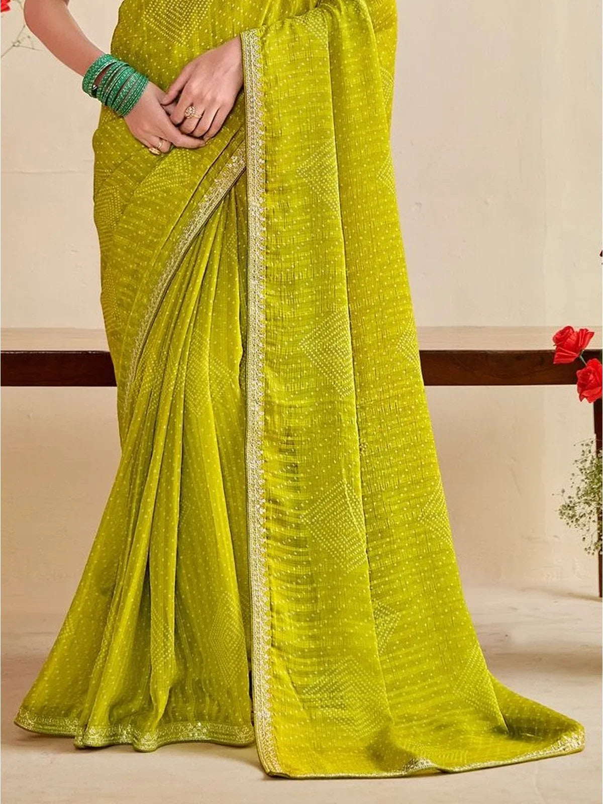 Tarani pallu and border closeup of green moss chiffon silk saree with lace work