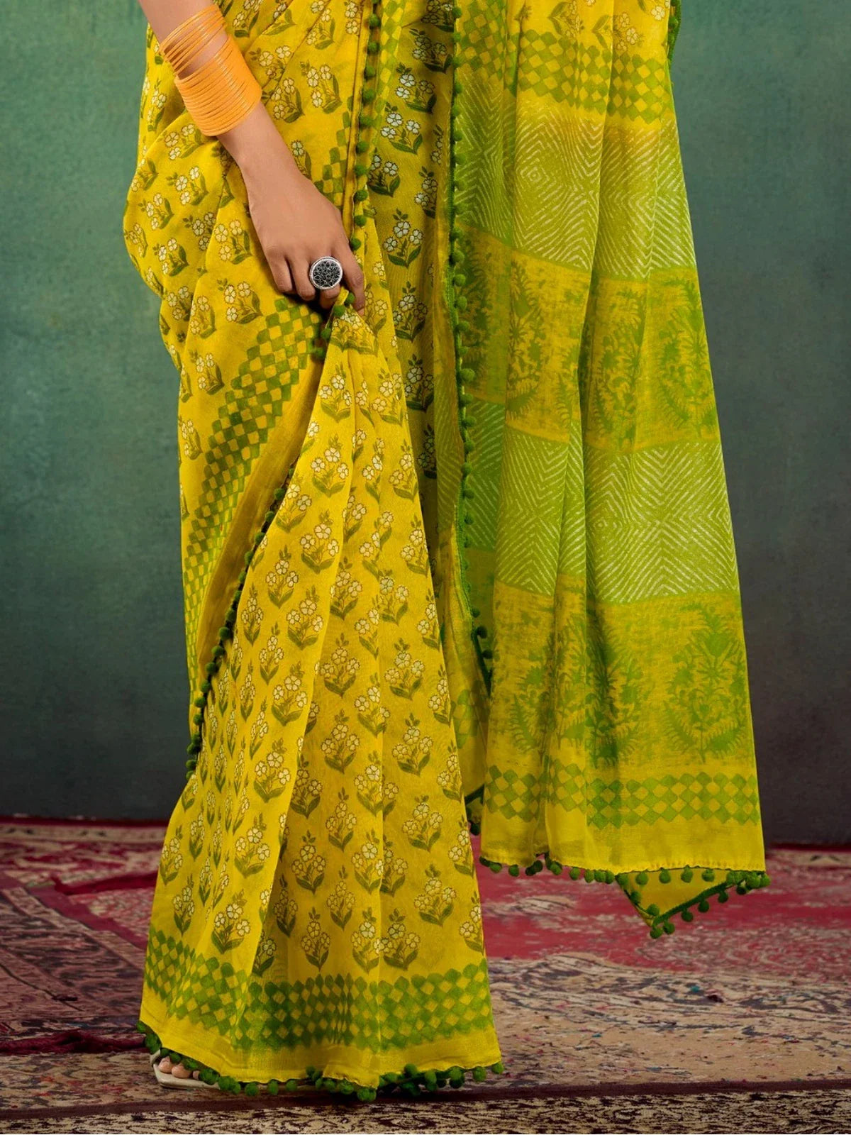Tarani yellow mul mul cotton saree pallu closeup showing intricate border and texture