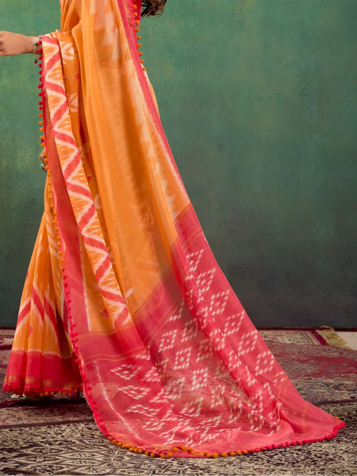 Tarani orange mul mul cotton saree pallu view highlighting woven patterns and border