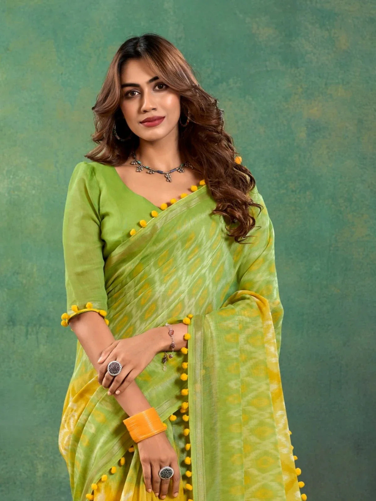 Tarani mul mul cotton green saree upper body view showing blouse and pom pom details