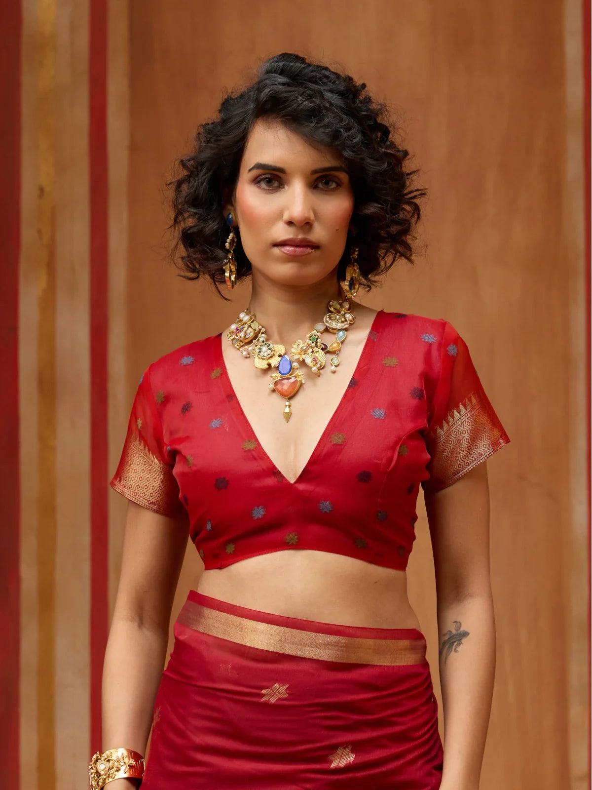 Tarani munga cotton handloom saree blouse closeup with zari sleeve and neat neckline in red tone