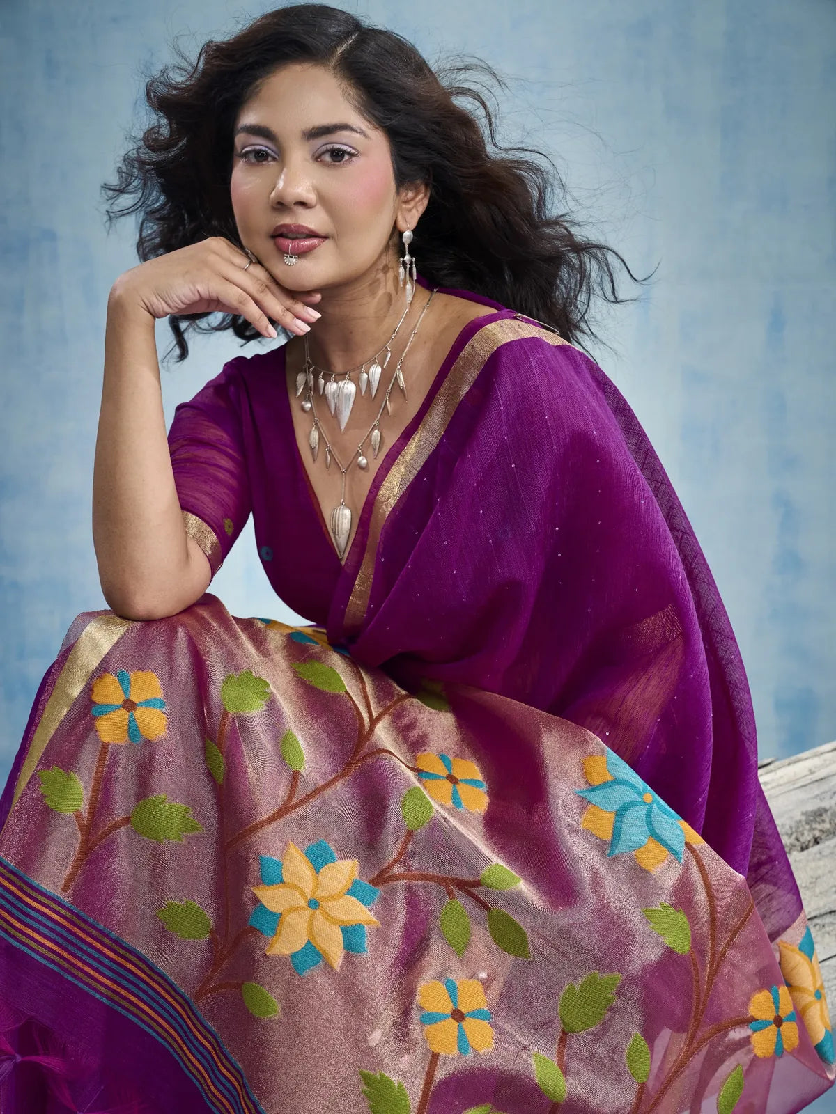 Tarani Bhanu pallu view of purple Munga silk saree with floral tissue pallu and tassels