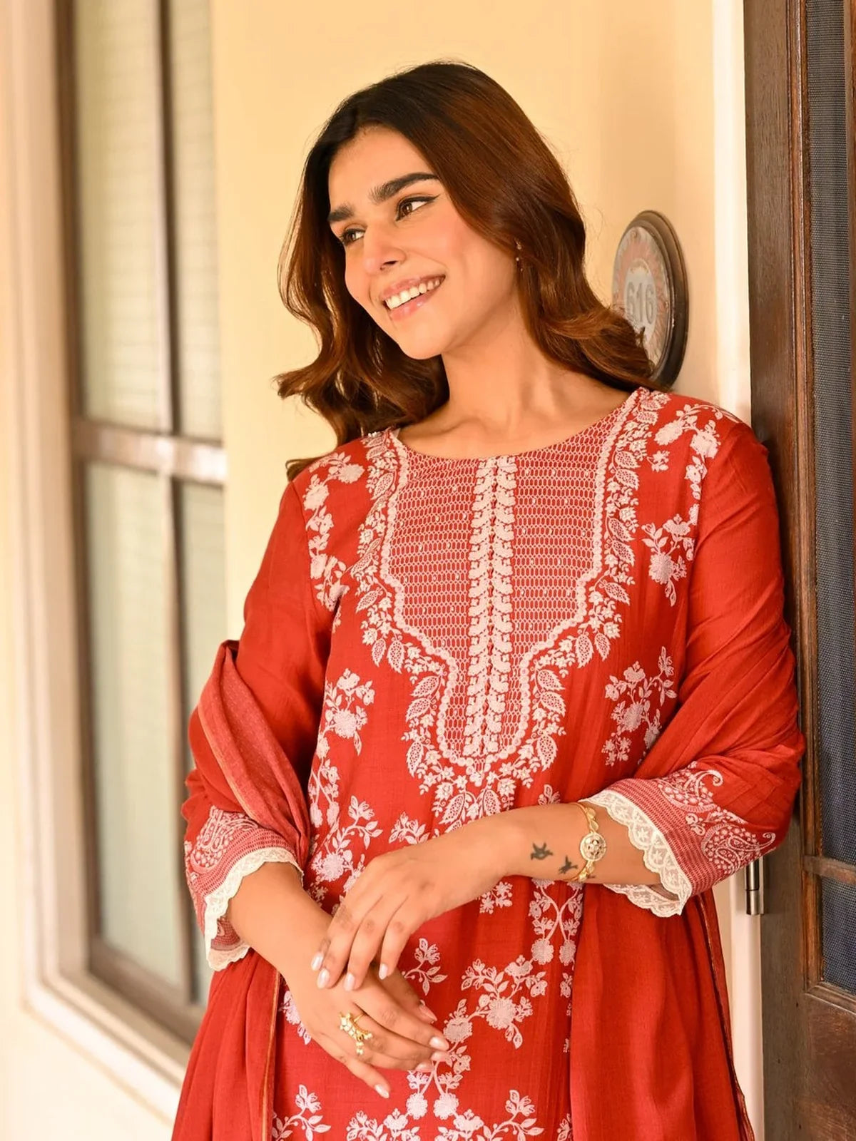 Tarani premium red muslin dress showcasing white floral embroidery in upper body view