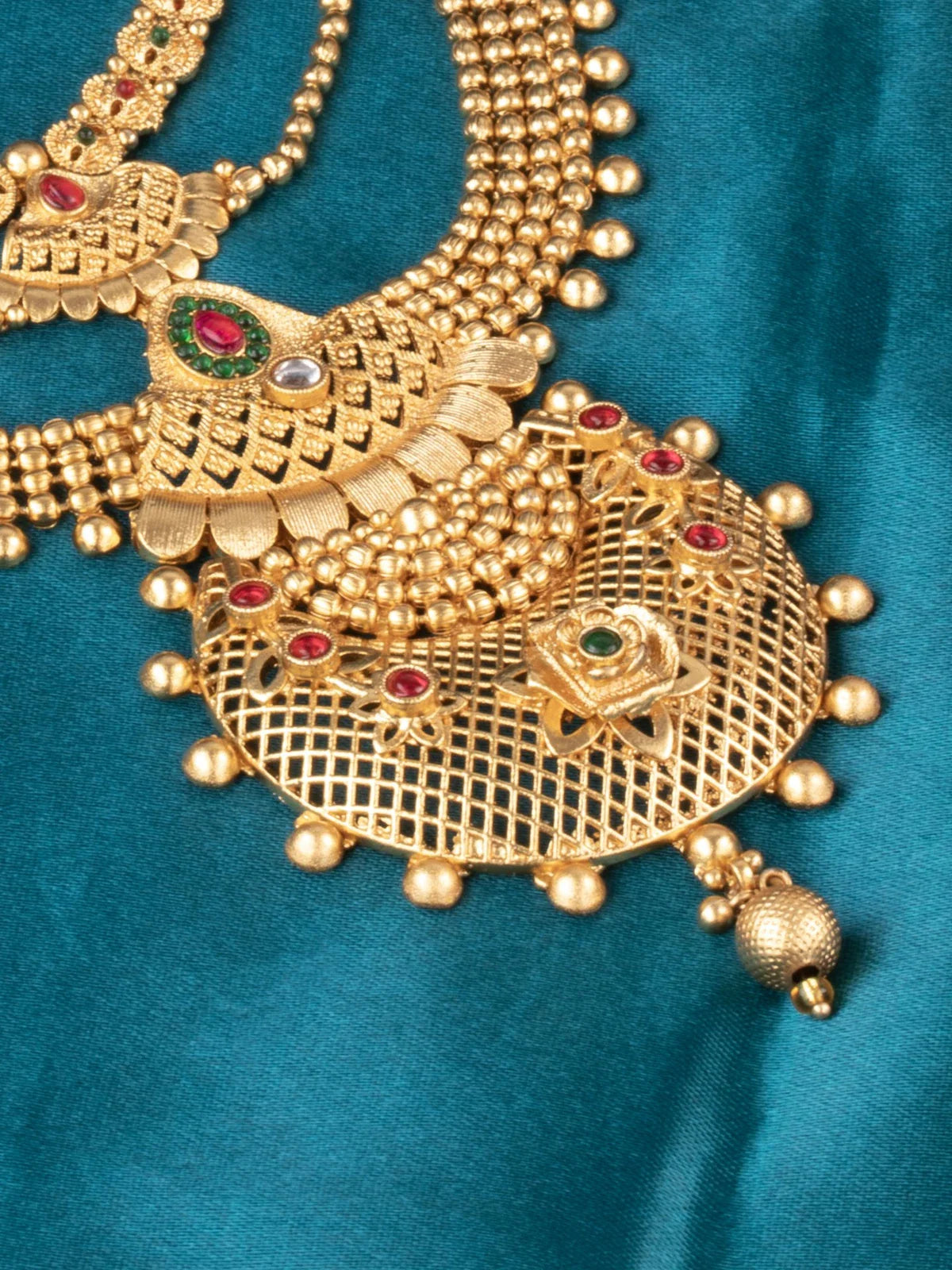 Tarani closeup of gold plated antique necklace with detailed stone work for festive wear