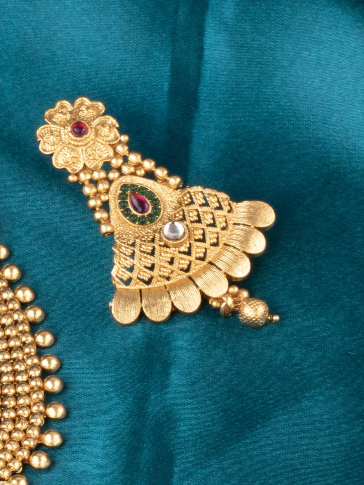 Tarani side view of designer gold plated antique necklace with earrings for bridal occasions