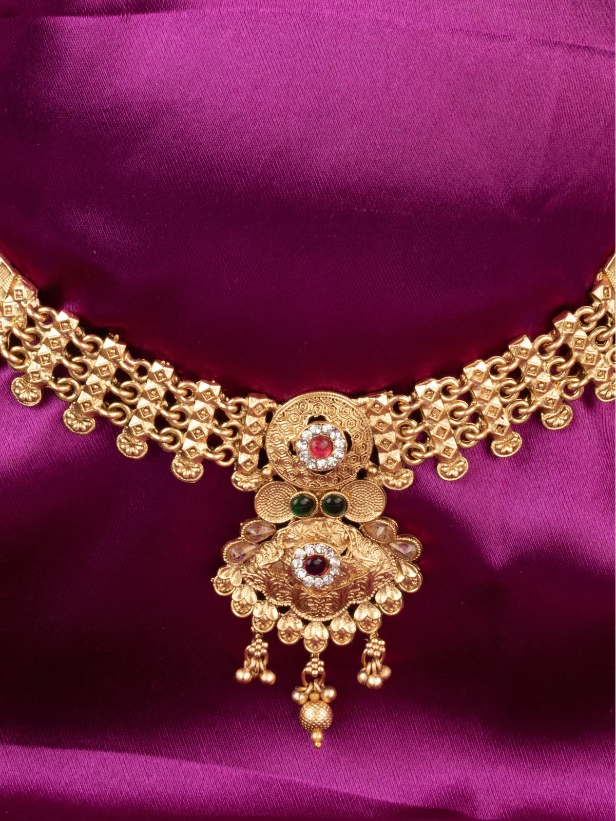 Tarani closeup view of gold plated necklace set showing intricate pendant design for festive occasions