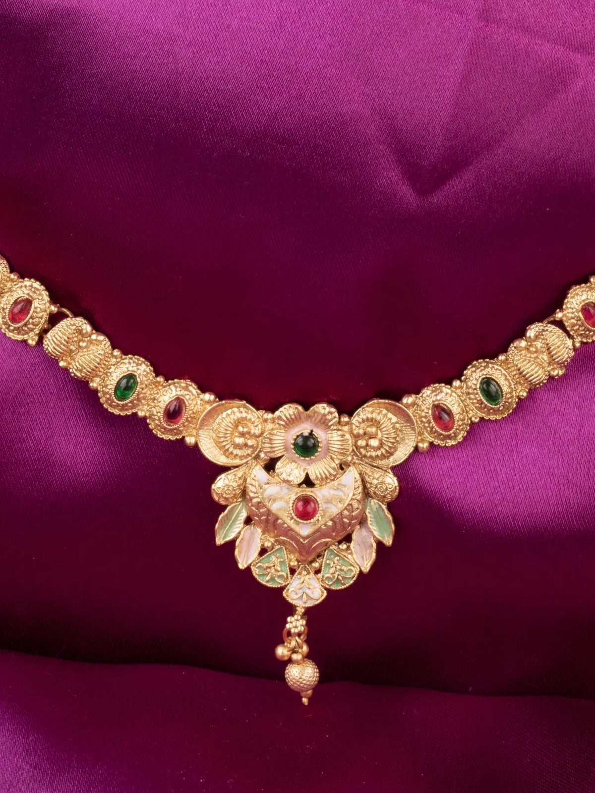 Tarani closeup view of gold plated stone studded necklace pendant for weddings