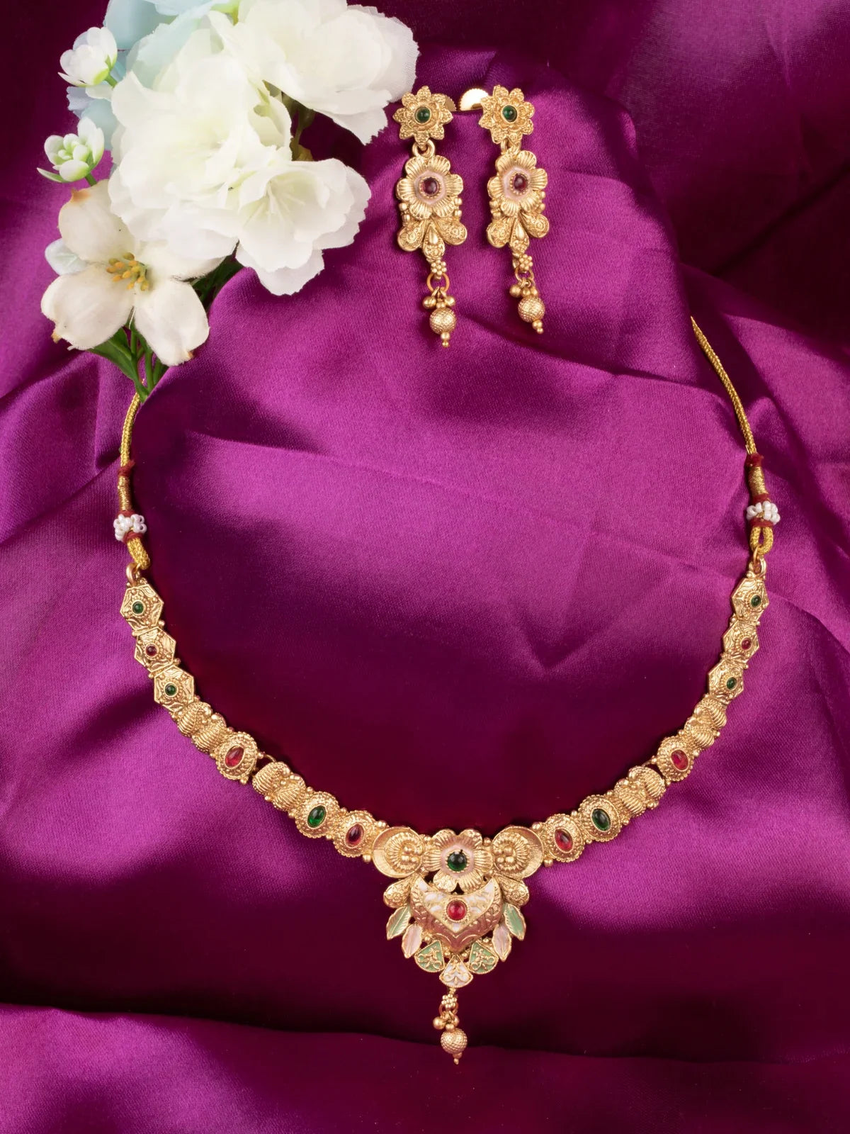Tarani gold plated stone studded necklace set with matching earrings for festive wear