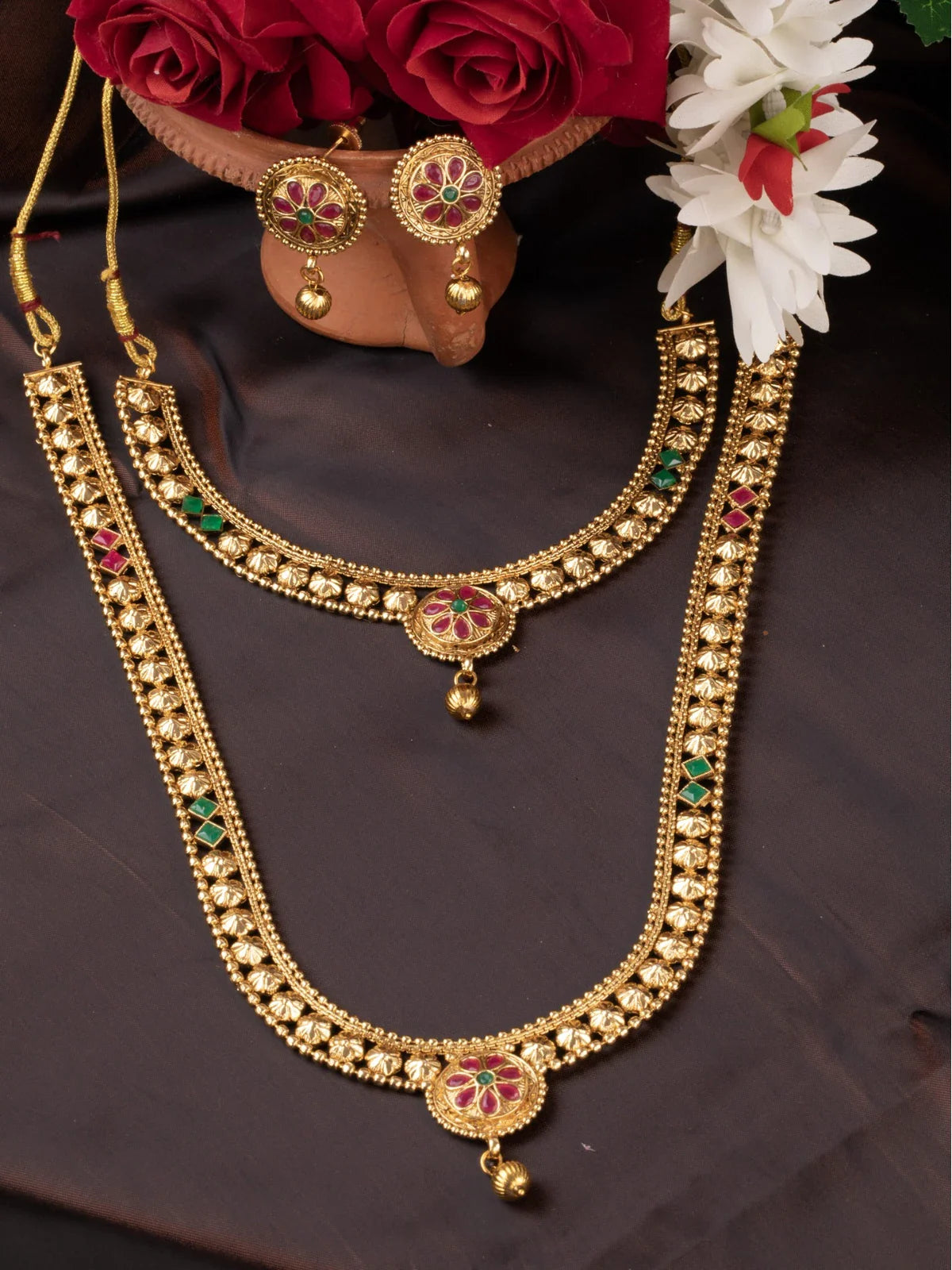 Tarani gold plated necklace set with red and green stone studded design for weddings