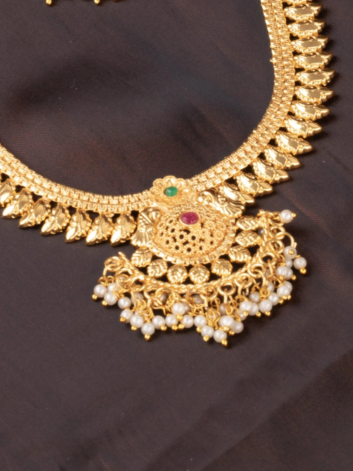 Tarani closeup view of gold plated necklace set showing pendant and pearl detailing