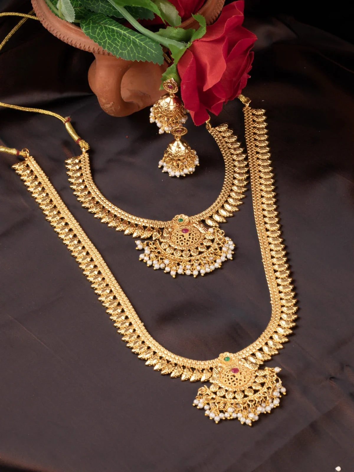 Tarani gold plated necklace set with pearl detailing and jhumka earrings for festive wear