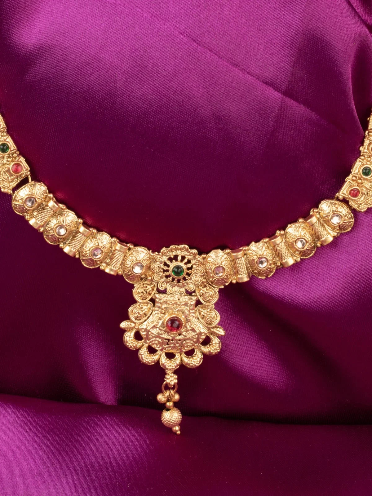 Tarani closeup view of gold plated necklace set showing antique stone detailing for festive occasions