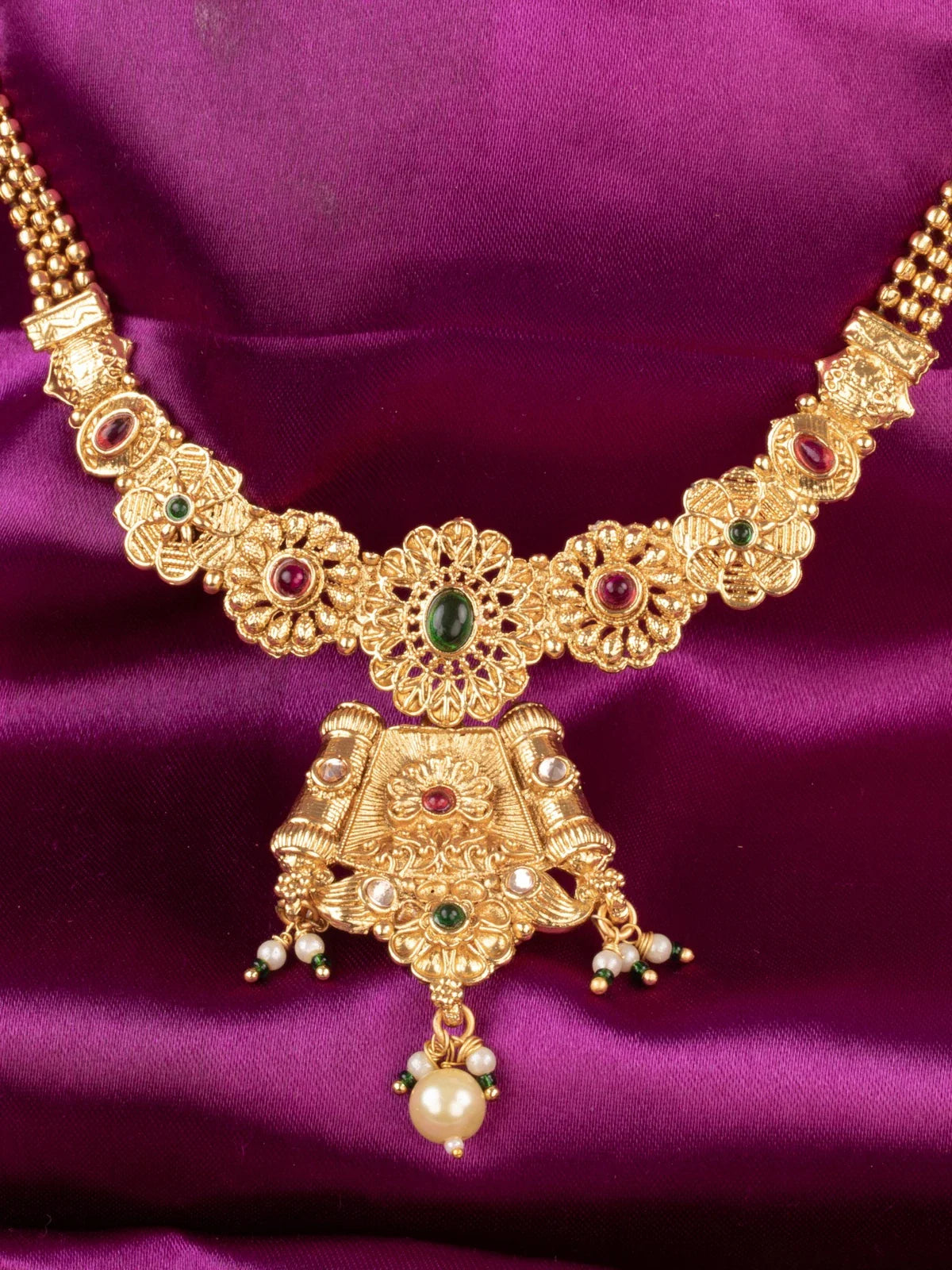 Tarani closeup gold plated necklace set showing detailed stone work for weddings and festive occasions