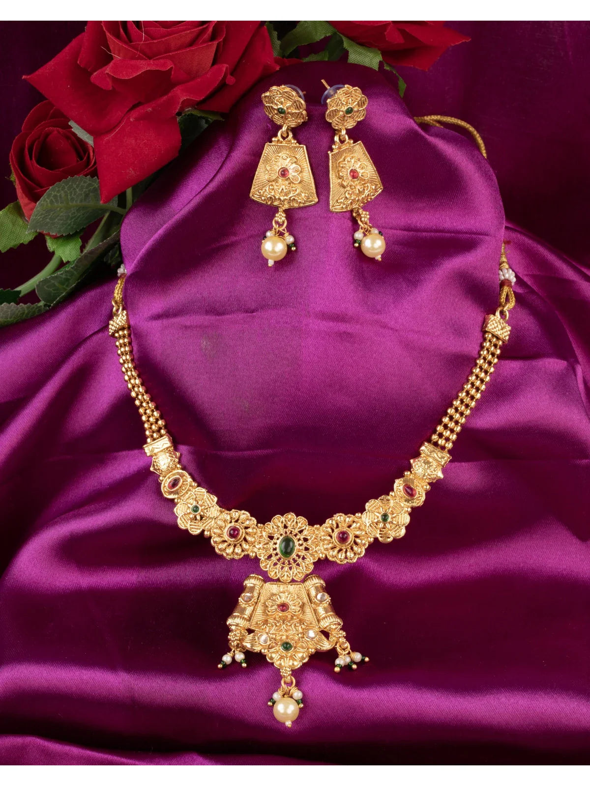 Tarani gold plated necklace set with red and green stone work and earrings for festive wear