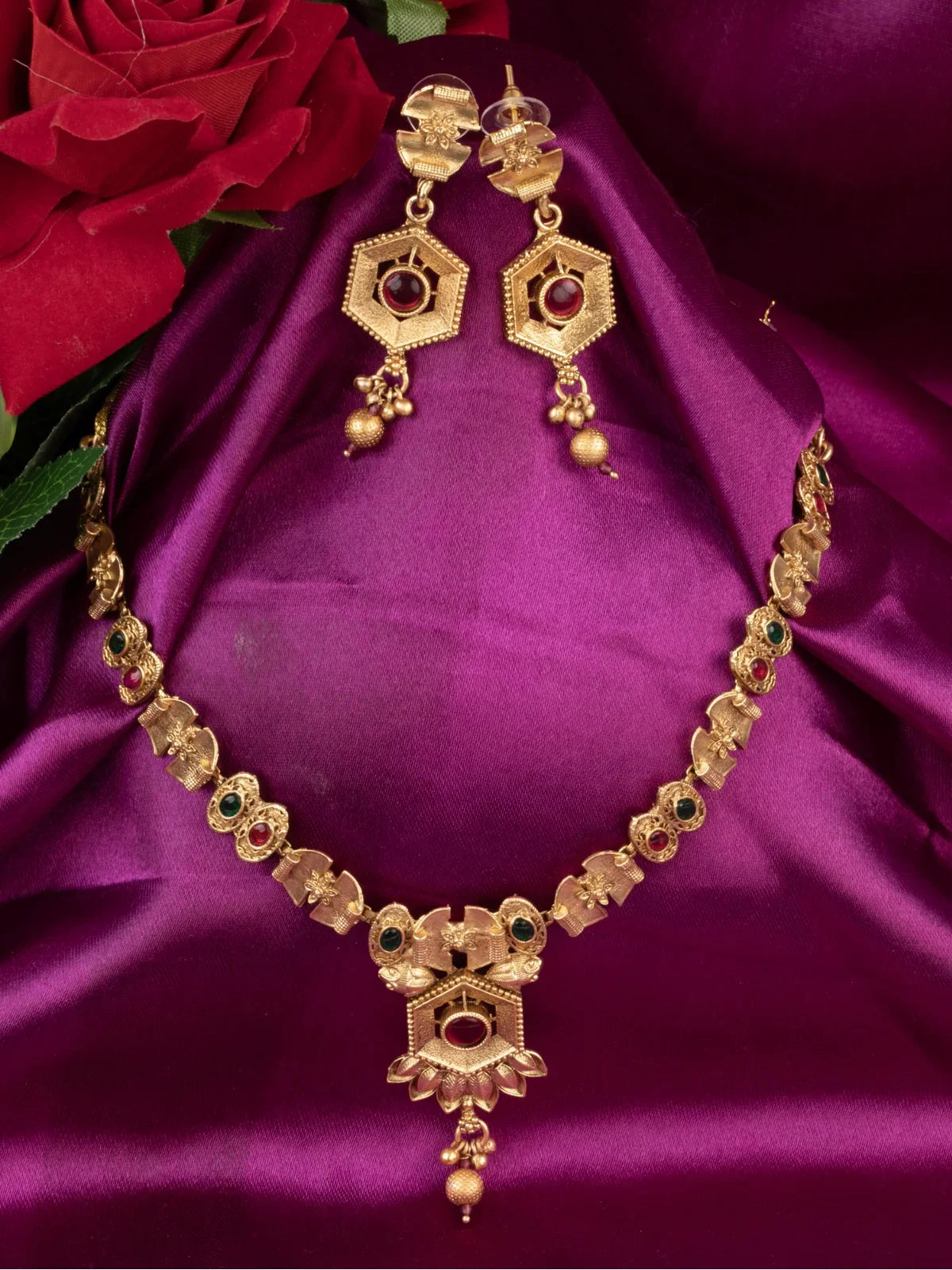 Tarani gold plated necklace set with red and green stone work and matching earrings for weddings and festive wear
