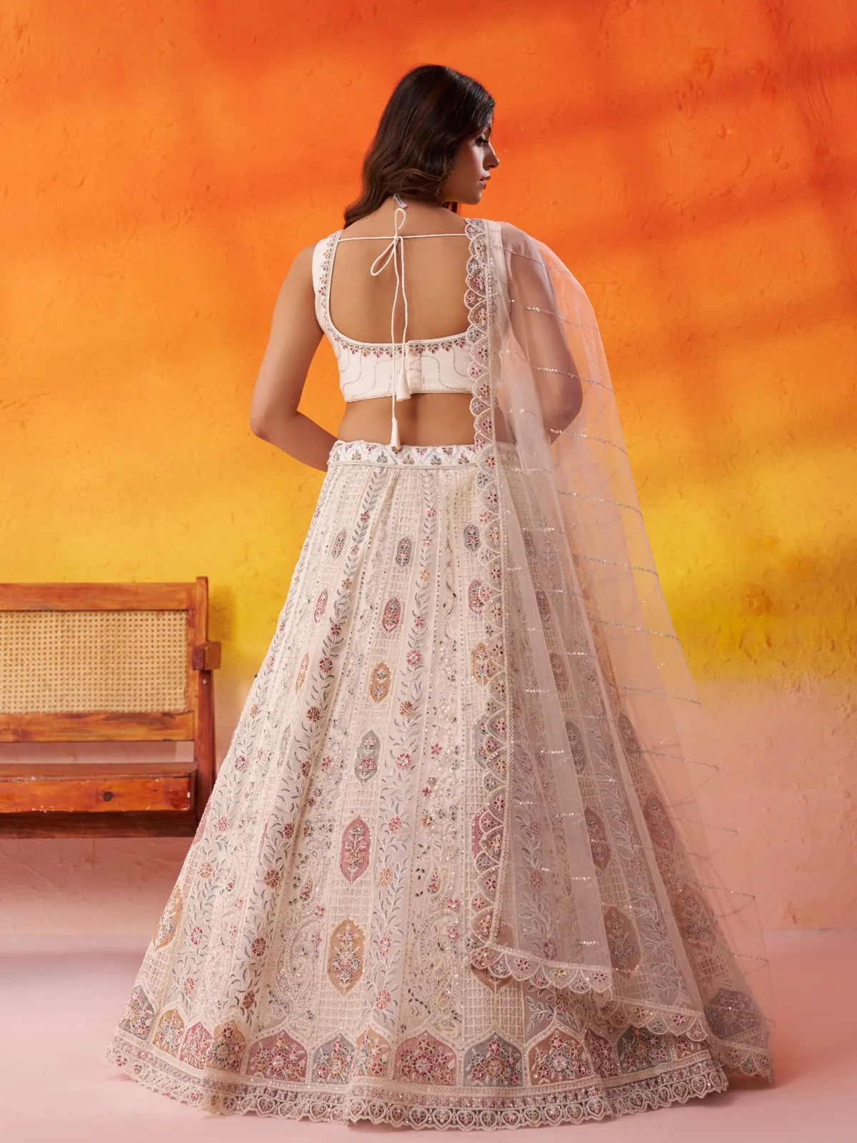 Tarani back view of net lehenga with tie-up blouse and cutwork dupatta border