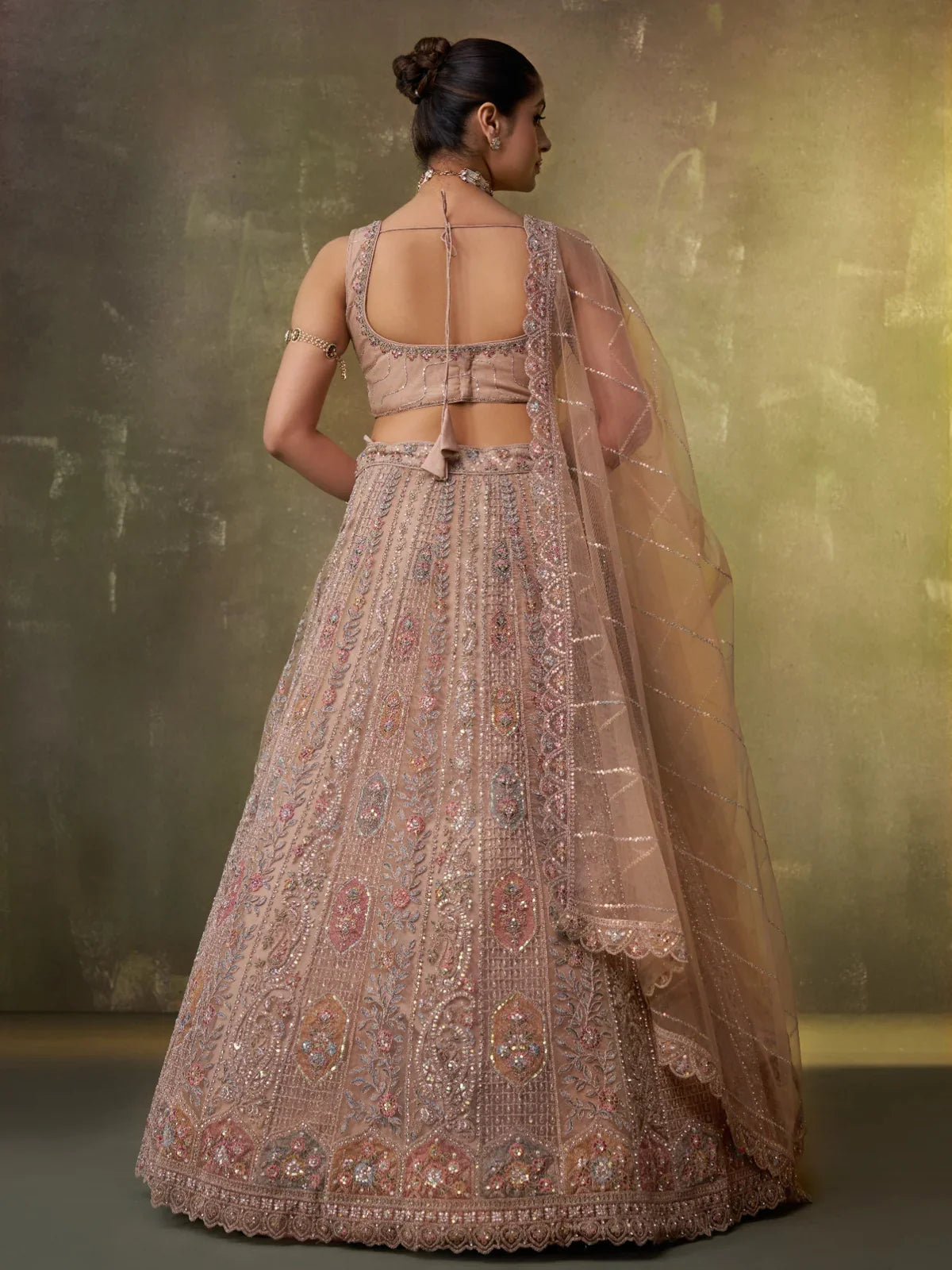 Tarani beige lehenga back view with tie-up blouse and cutwork dupatta border