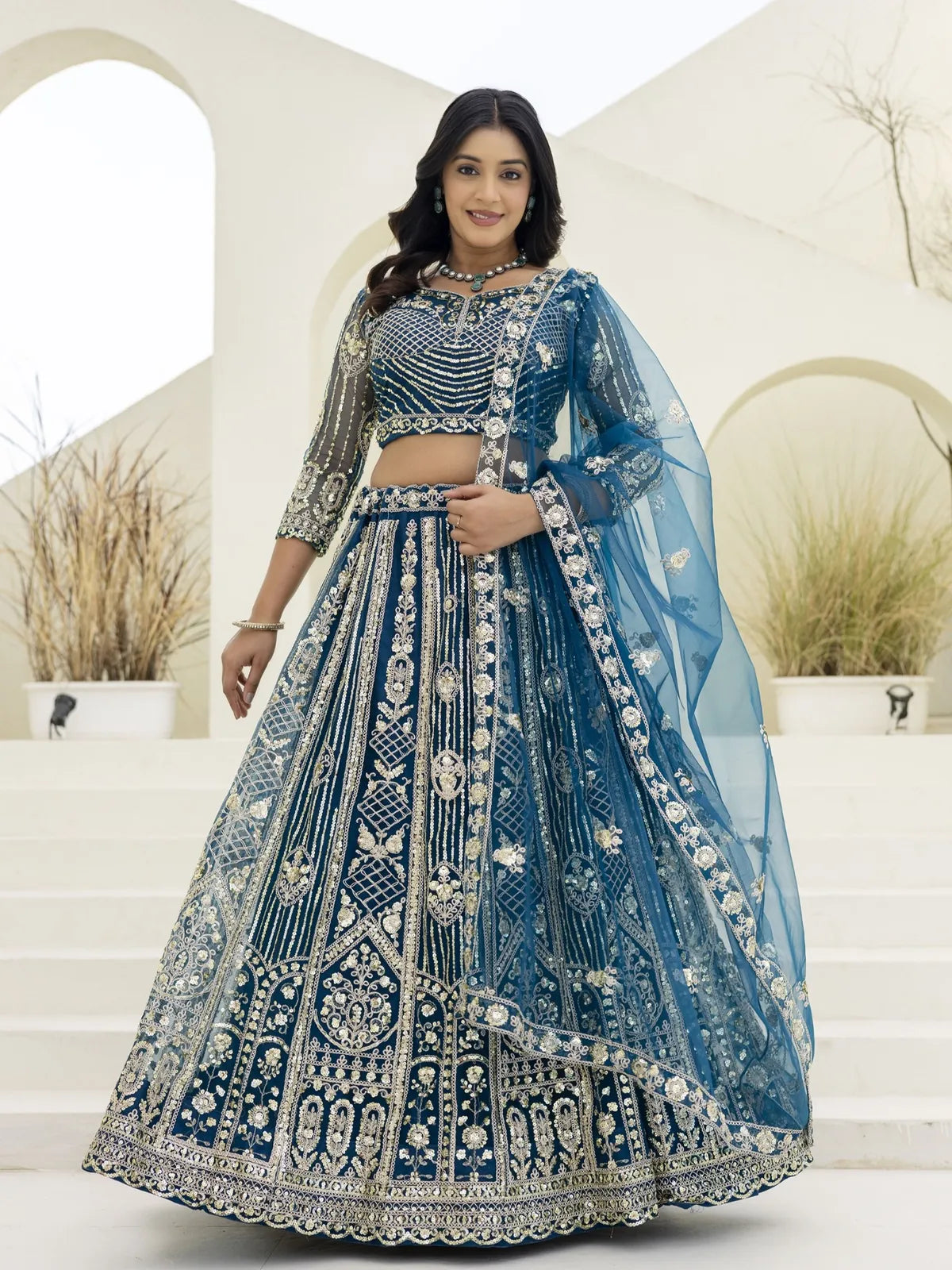Tarani blue net lehenga with heavy sequins and codding embroidery work in full view, ideal for festive and wedding wear