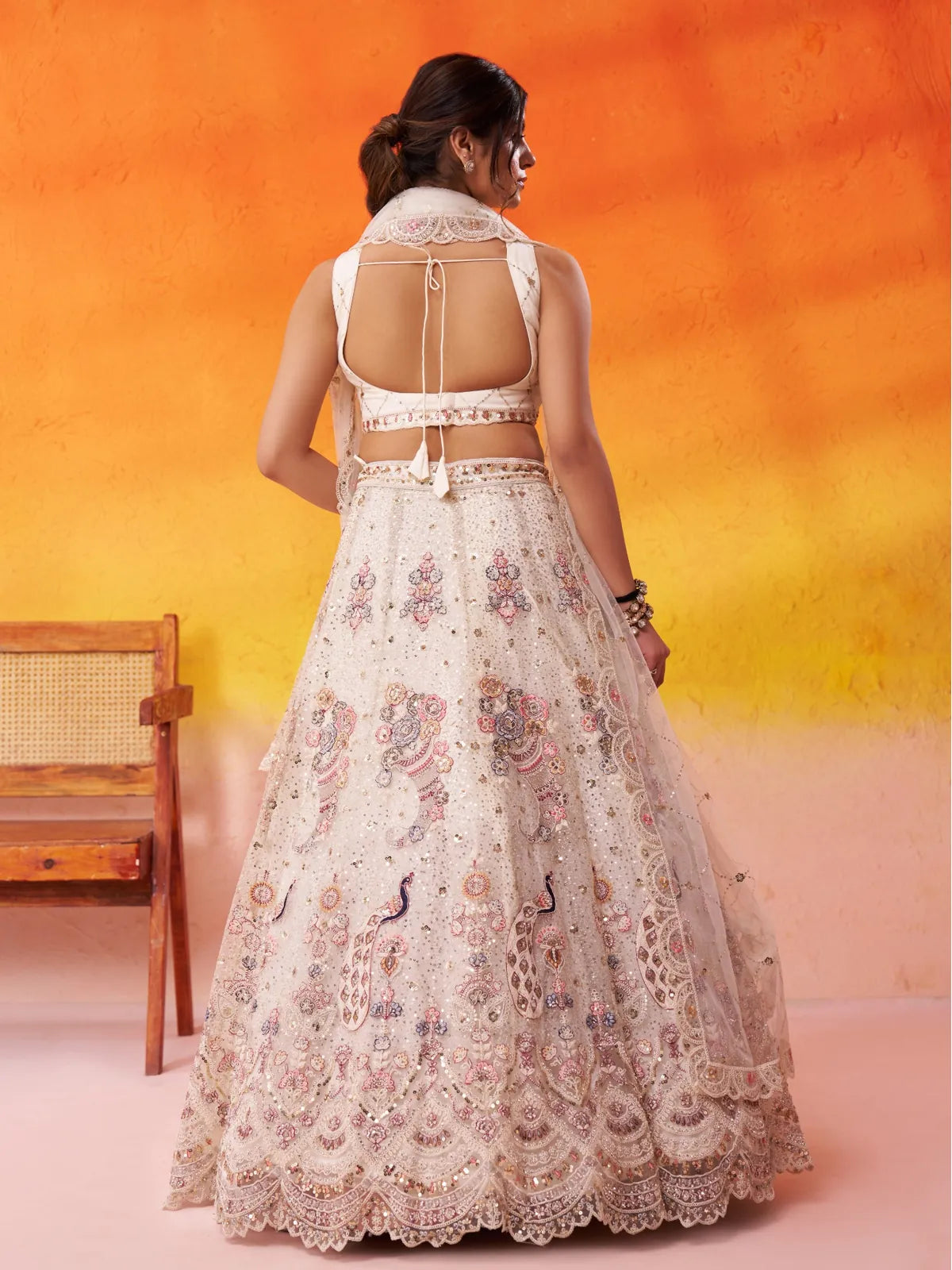 Tarani cream net lehenga with back view showcasing sequins embroidery and traditional detailing