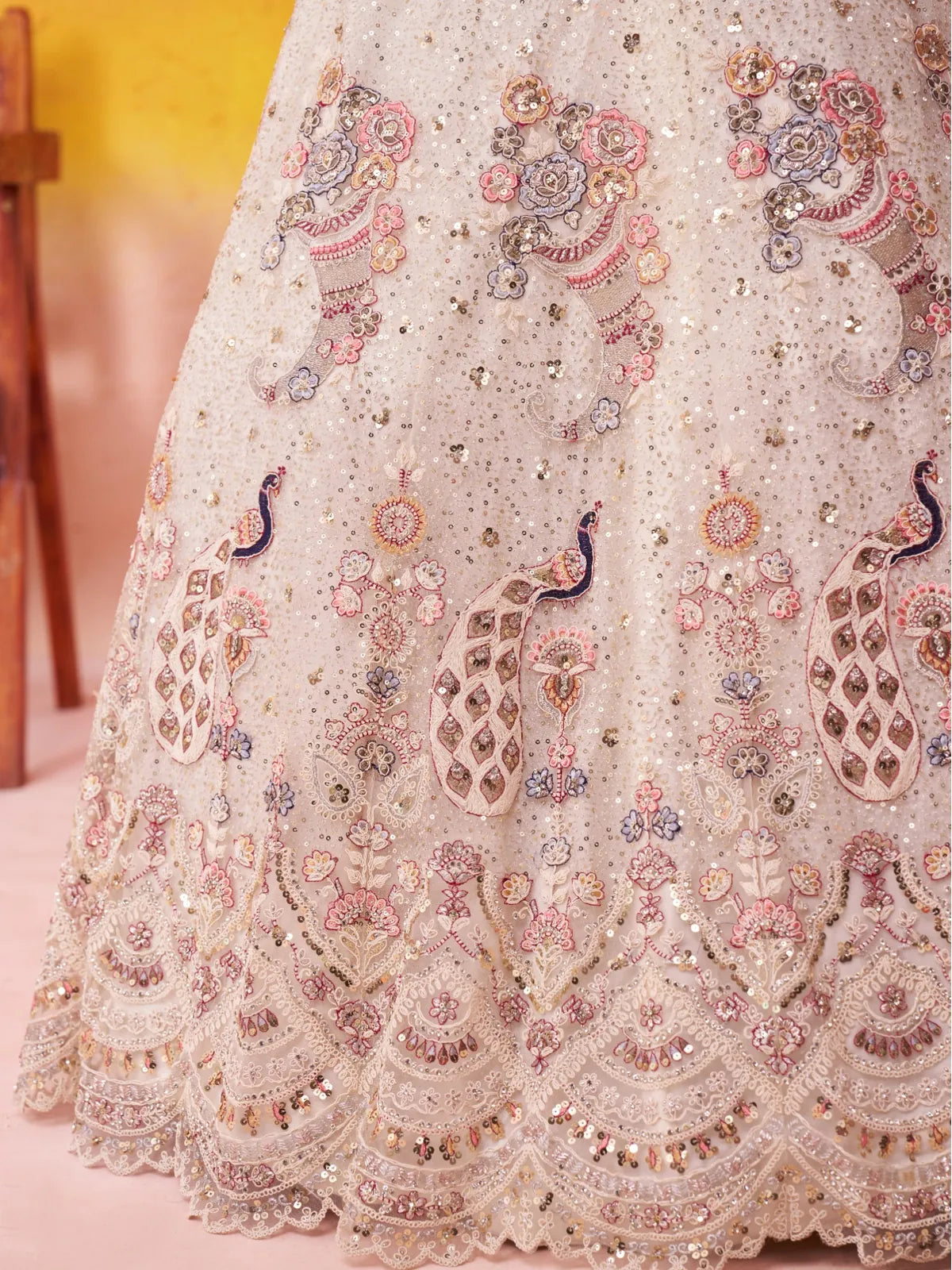 Tarani cream net lehenga with closeup view showcasing sequins embroidery and traditional detailing