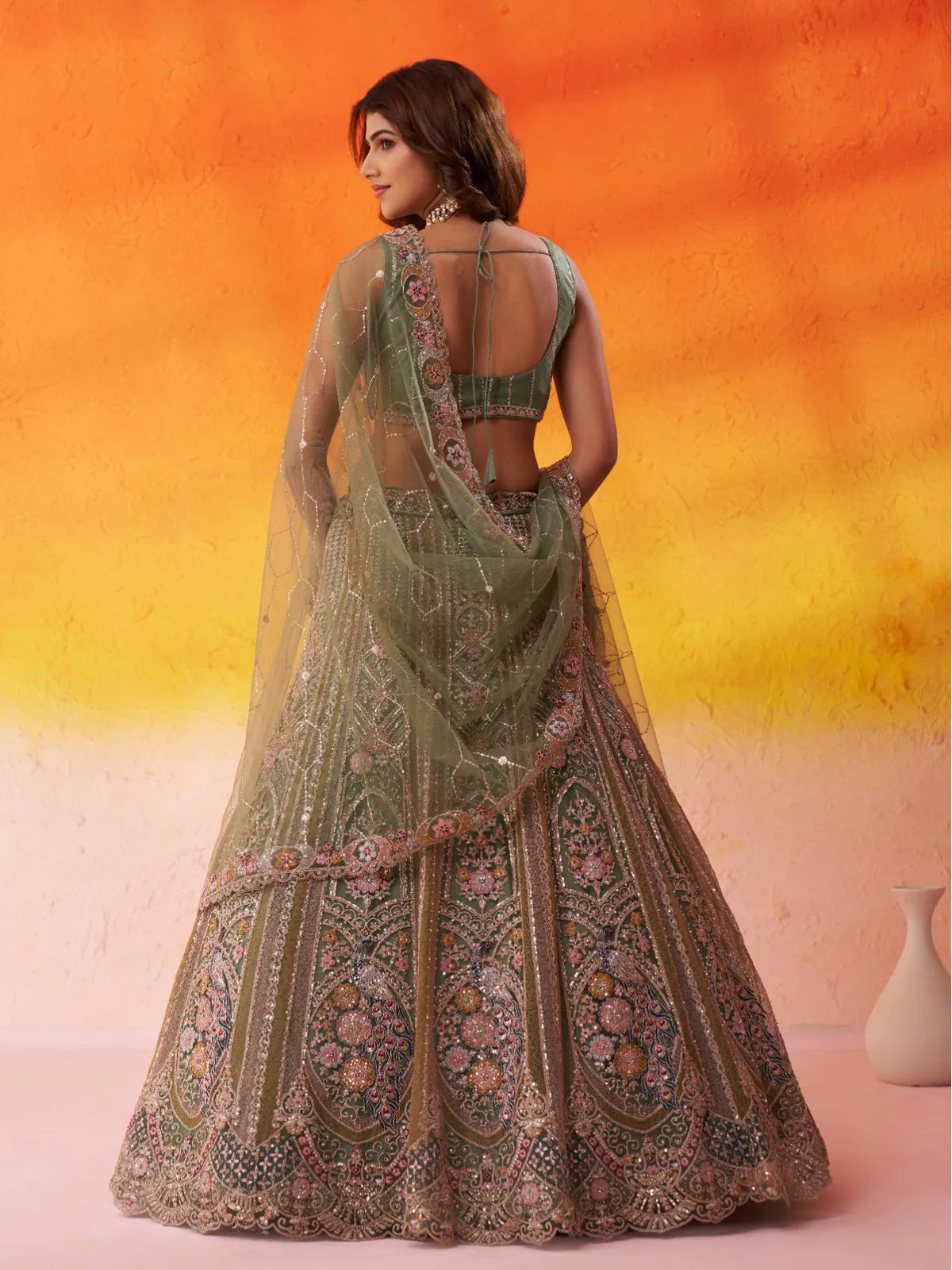 Tarani green net lehenga back view with detailed blouse and dupatta fall