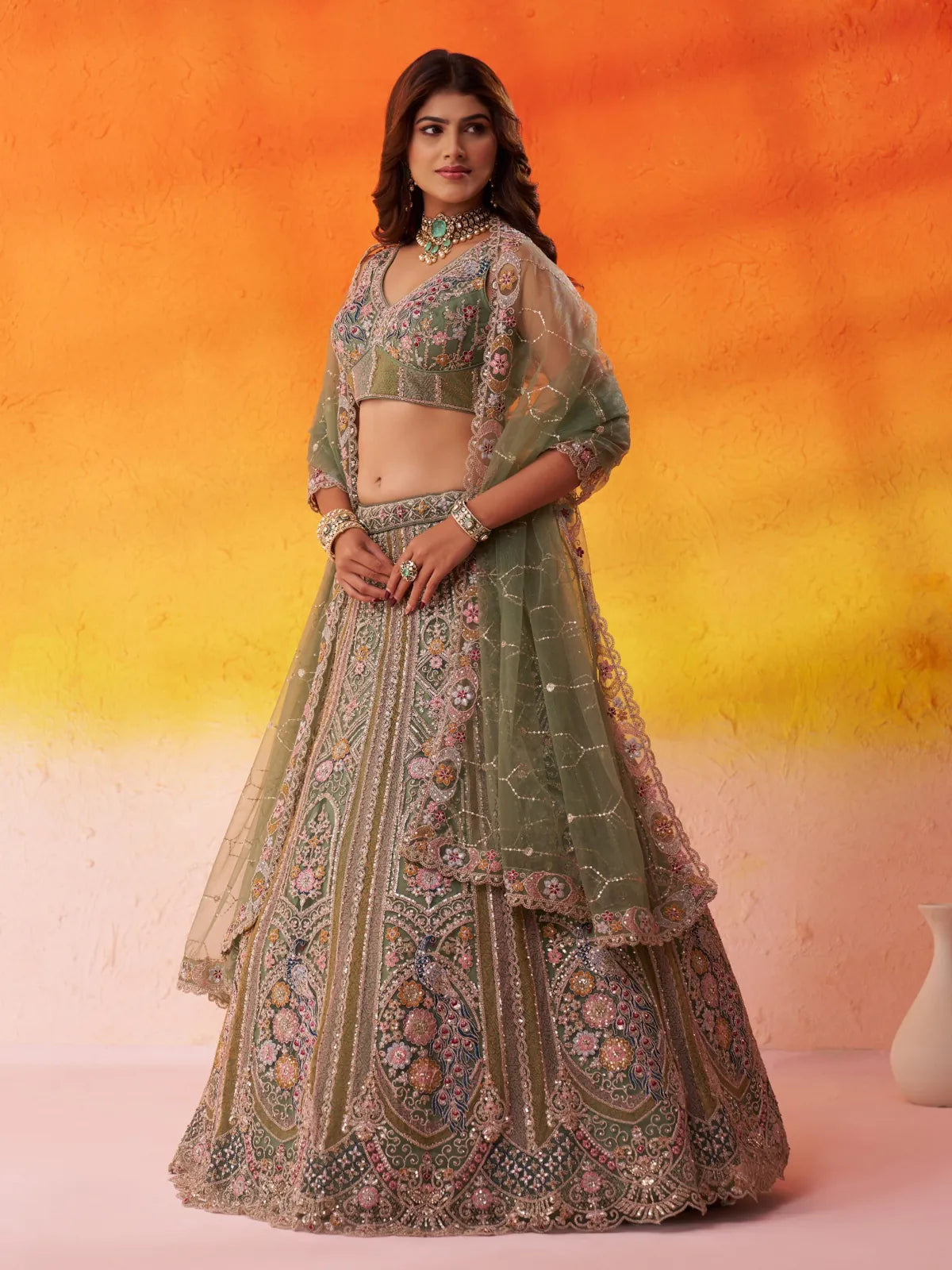 Tarani green net lehenga side pose showing dupatta and thread work