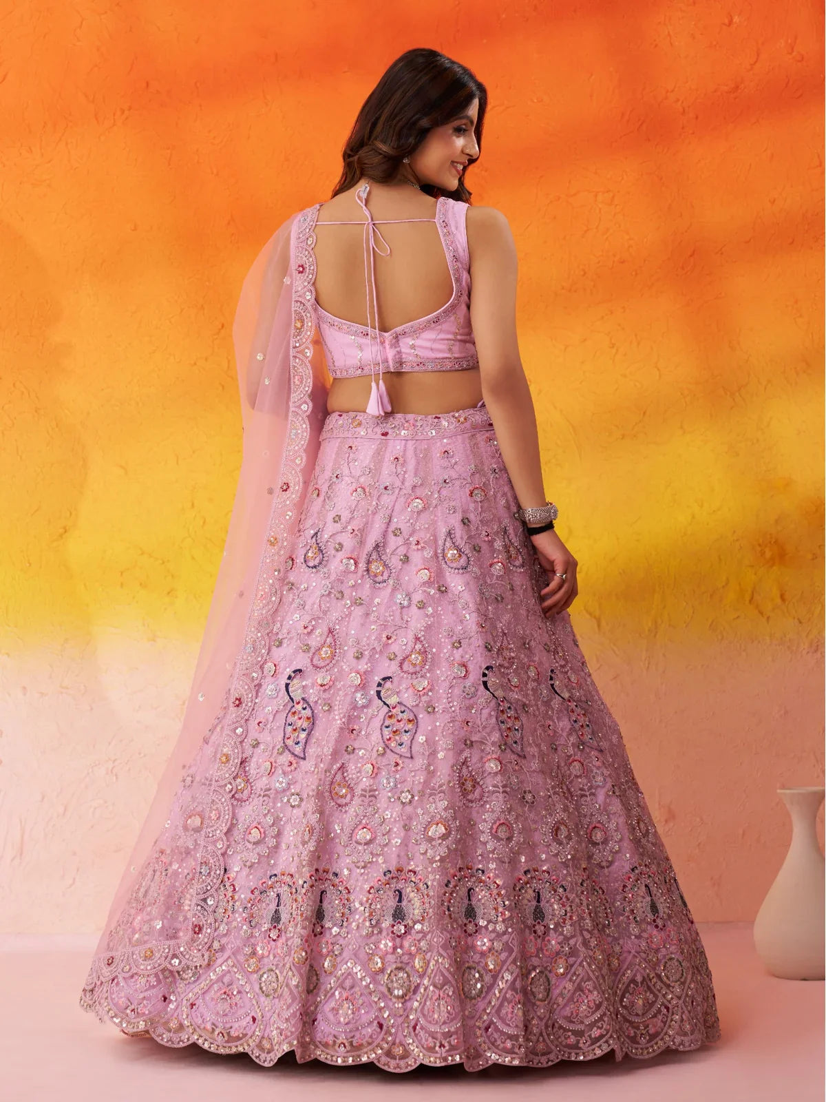 Tarani pink lehenga back design featuring tie-up blouse and intricate embroidery all over