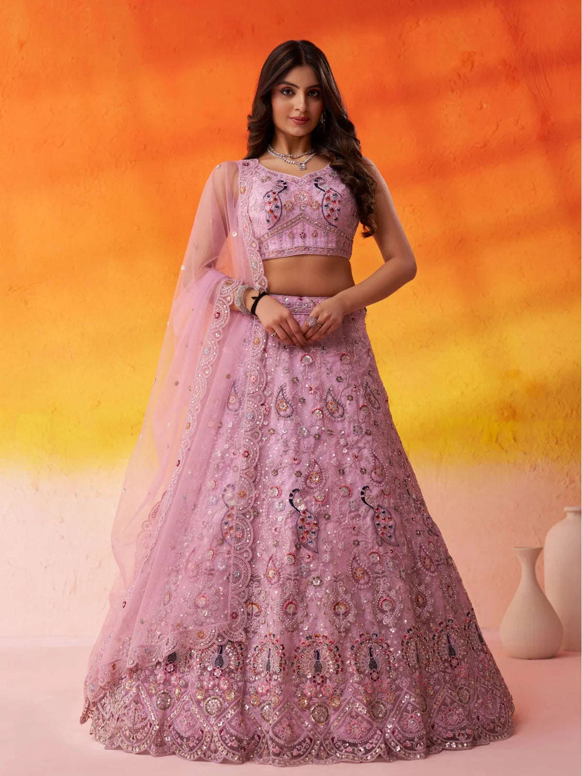 Tarani net pink lehenga full view with heavy sequin and thread embroidery featuring peacock motifs and mirror work