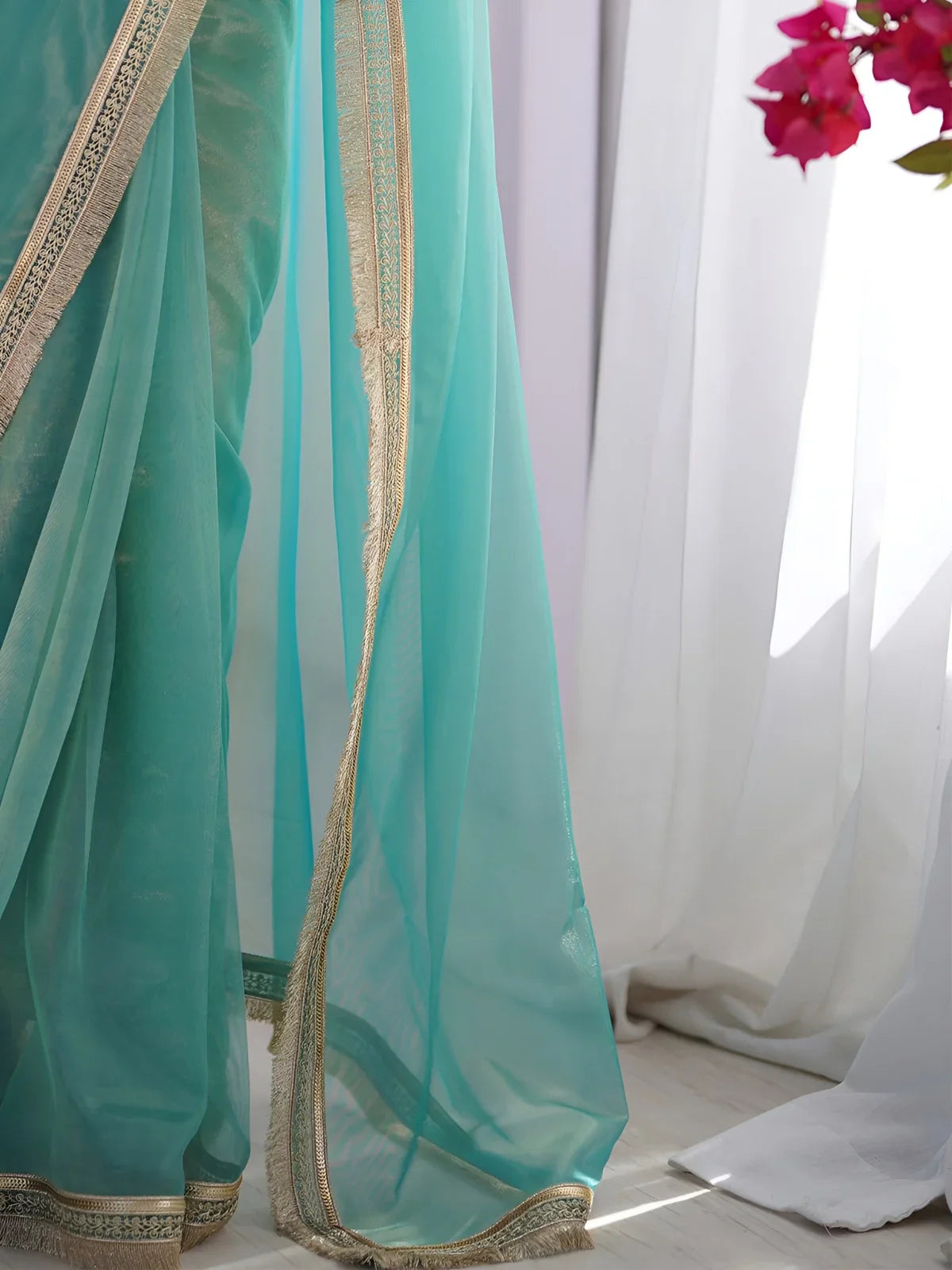 Tarani green soft net saree with lace detailing and transparent finish closeup view